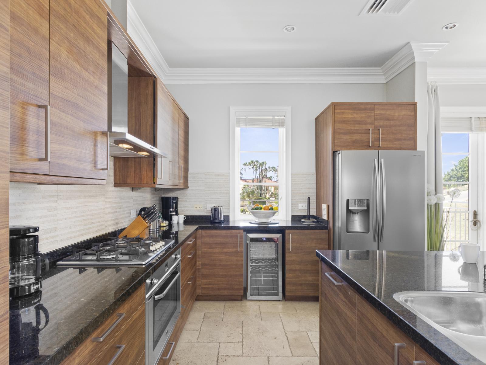 Unleash your inner chef in our fully equipped kitchen, featuring an ice maker, wine fridge, oven, coffee maker, and a convenient kitchen island for all your culinary adventures.