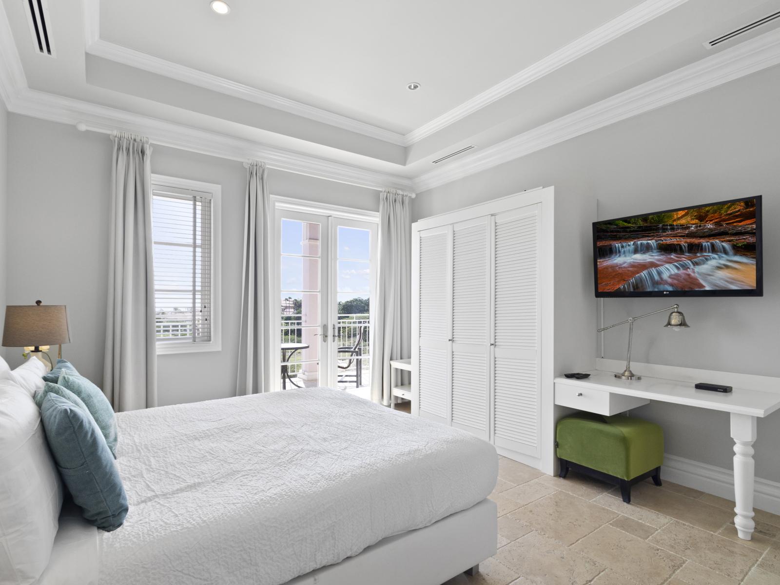 Your retreat, our main bedroom – complete with a desk for work, a balcony for relaxation, and a Smart TV for entertainment_