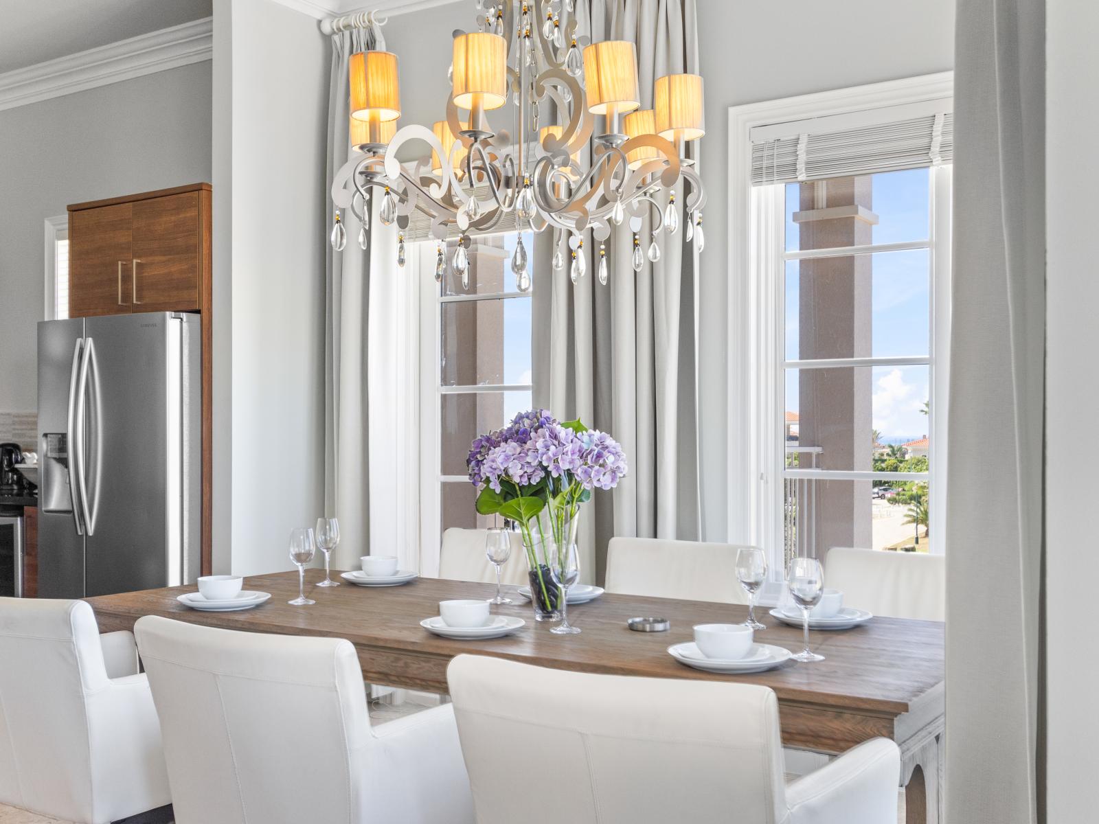 Elegant dining for six under the sparkling chandelier - a perfect setting for shared moments and delicious meals.