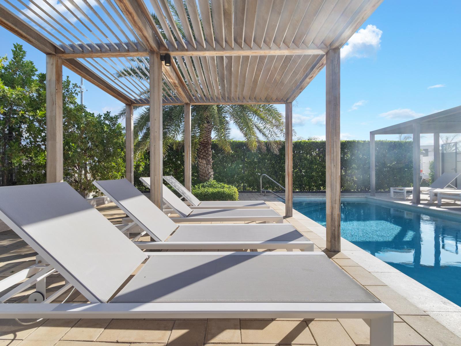 Relax under the shade at the Tuscany residence community pool