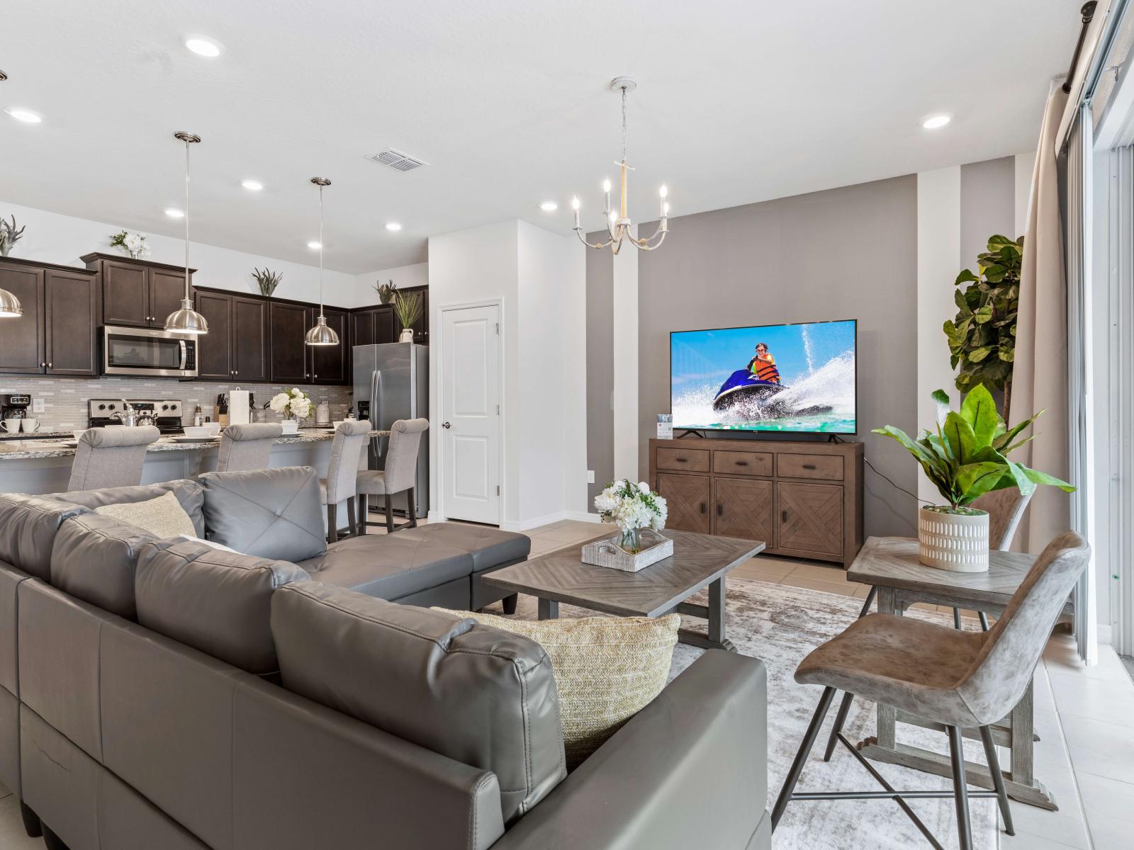 The living area, adorned with a sleek smart TV, becomes the focal point for relaxation and enjoyment.