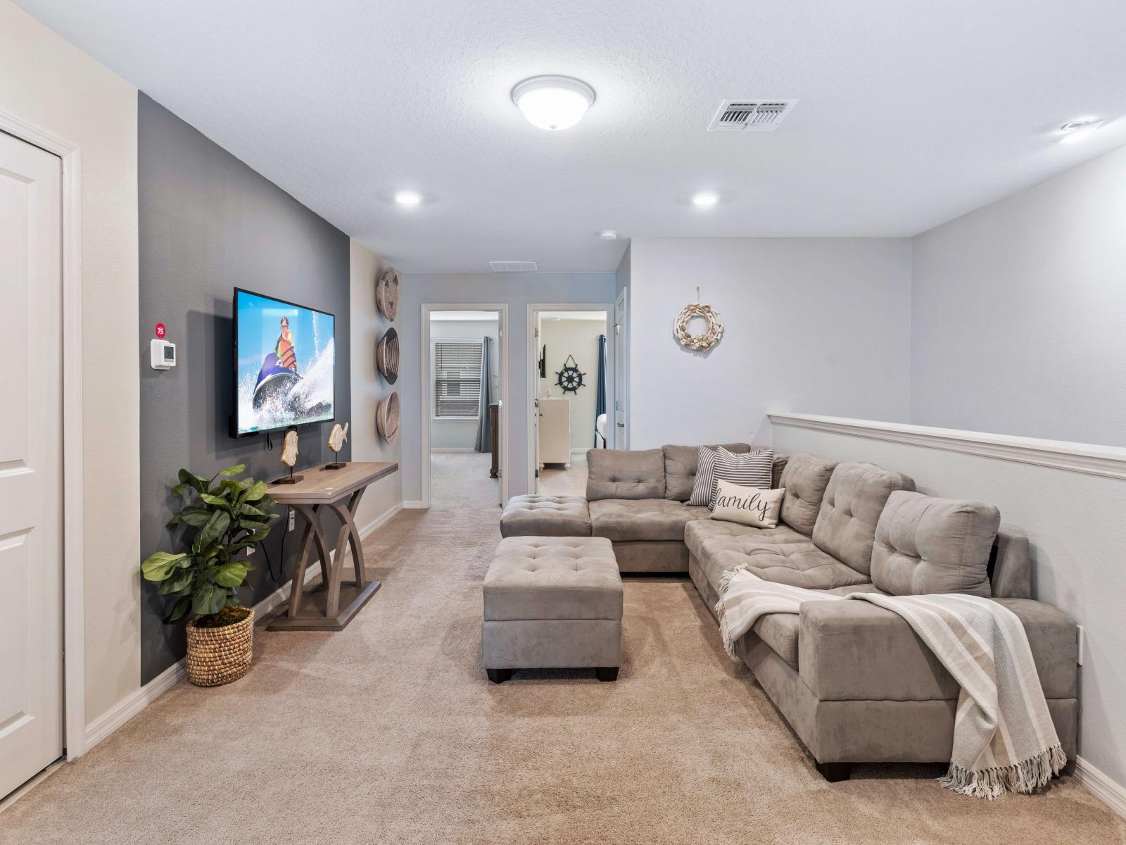 Enjoy a movie night in our stylish loft living area, complete with a plush sofa and TV.