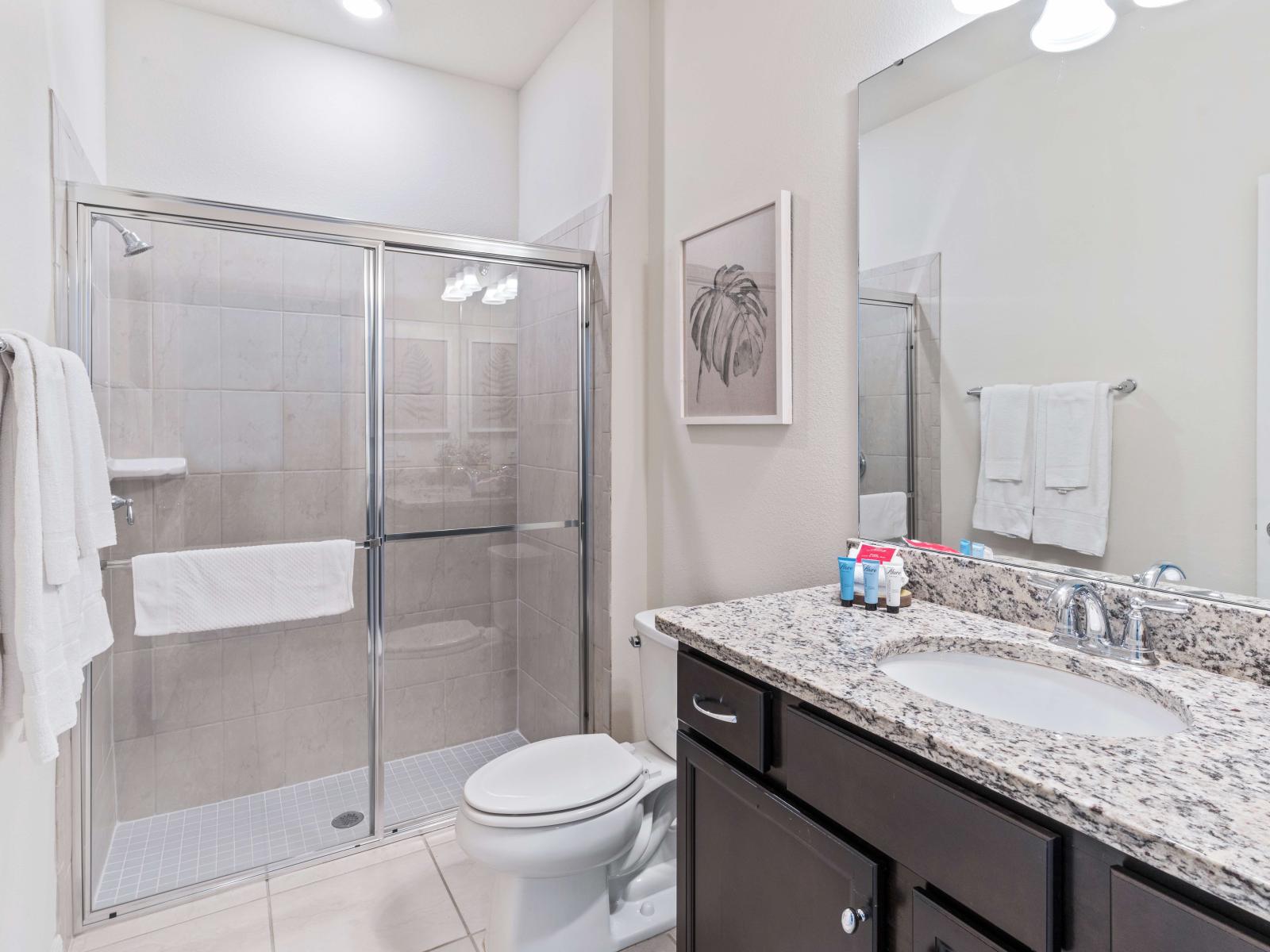 Indulge in a spa-like experience with the walk-in shower in the first bedroom's en-suite bathroom.