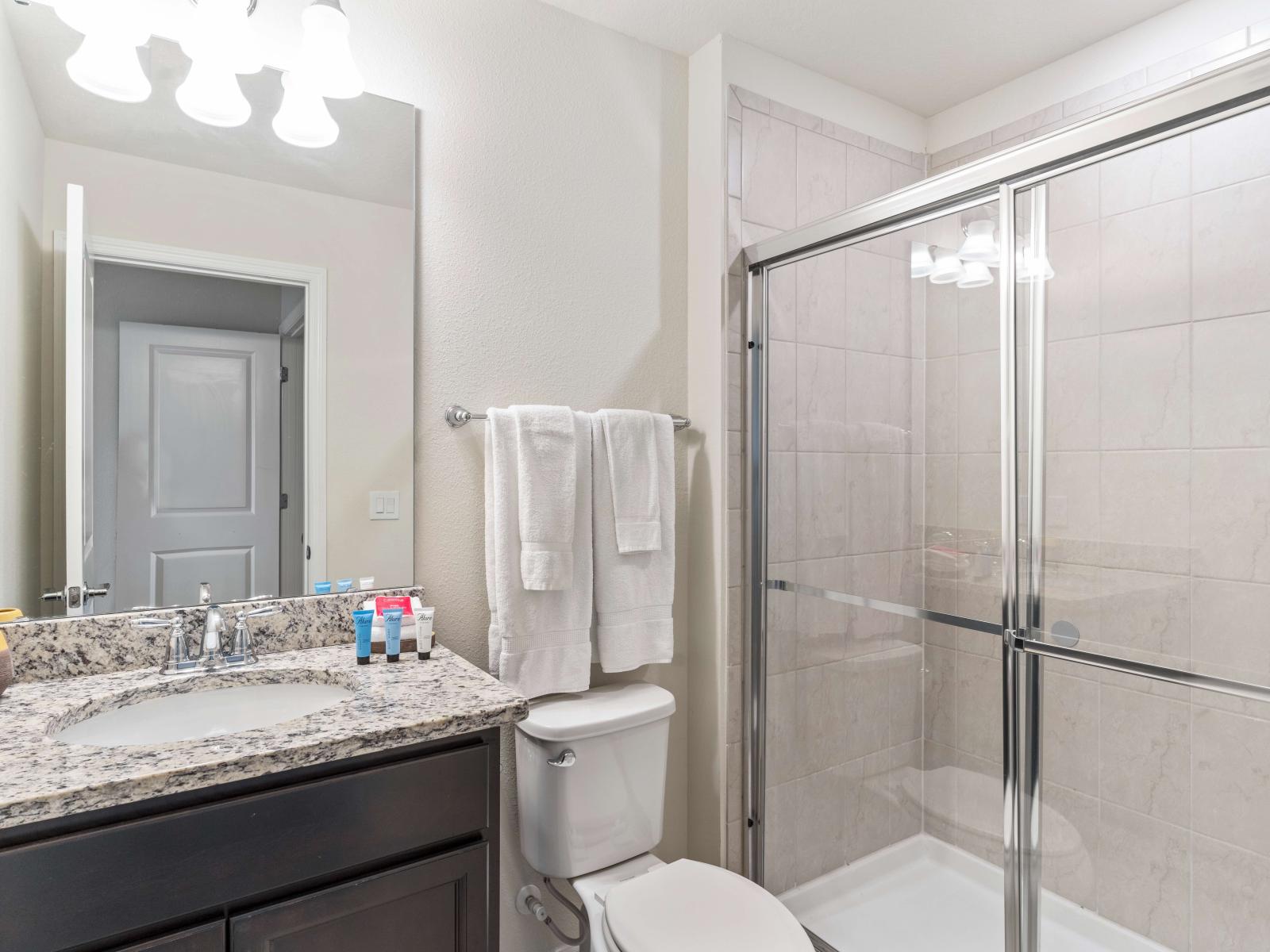 Refreshing Escape: Bathroom 3 boasts a spacious walk-in shower, offering a refreshing escape from the day's hustle. A serene oasis where relaxation flows freely, promising rejuvenation with every drop.