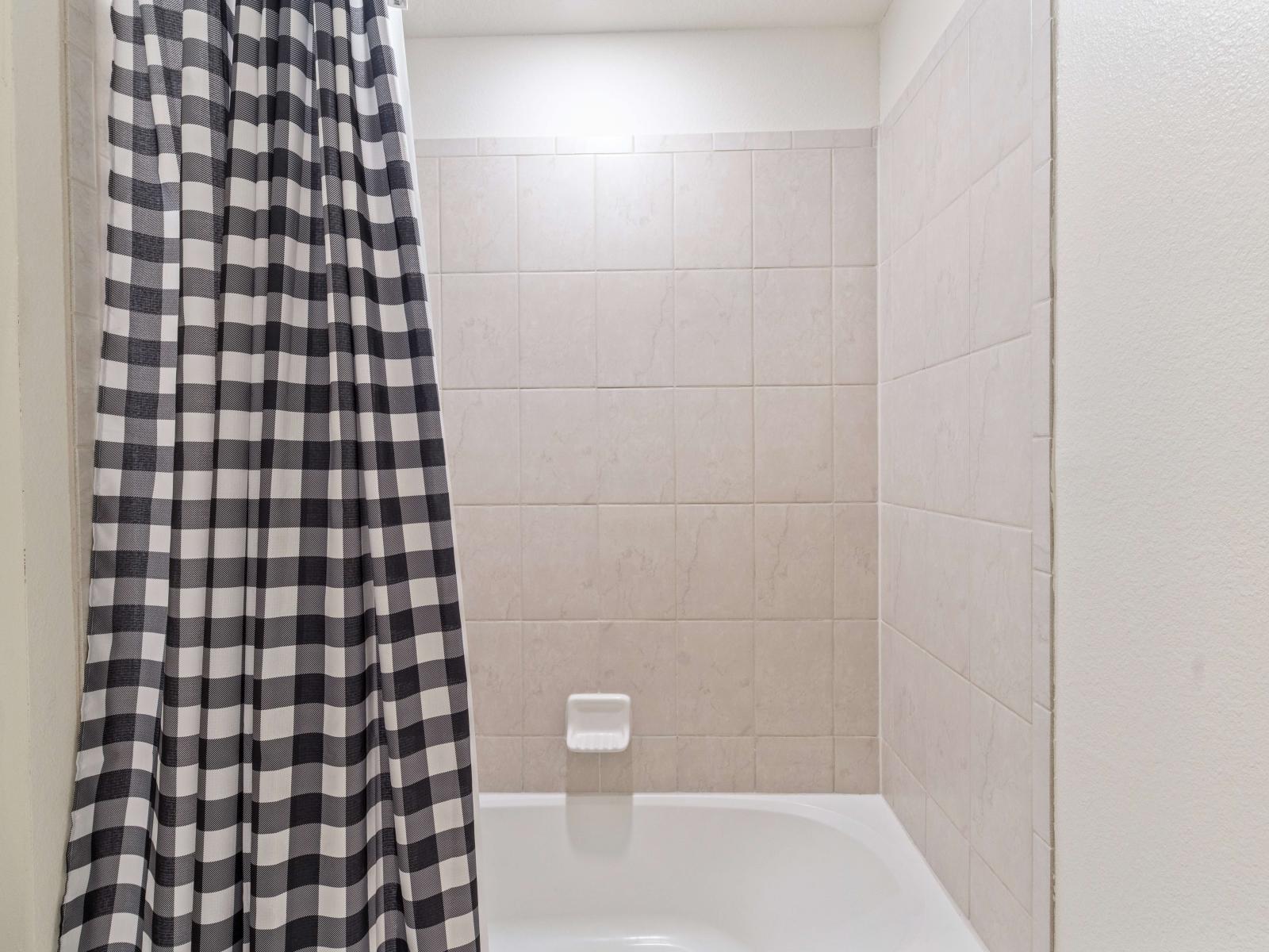 Bathroom 4 with a bathtub and shower combination