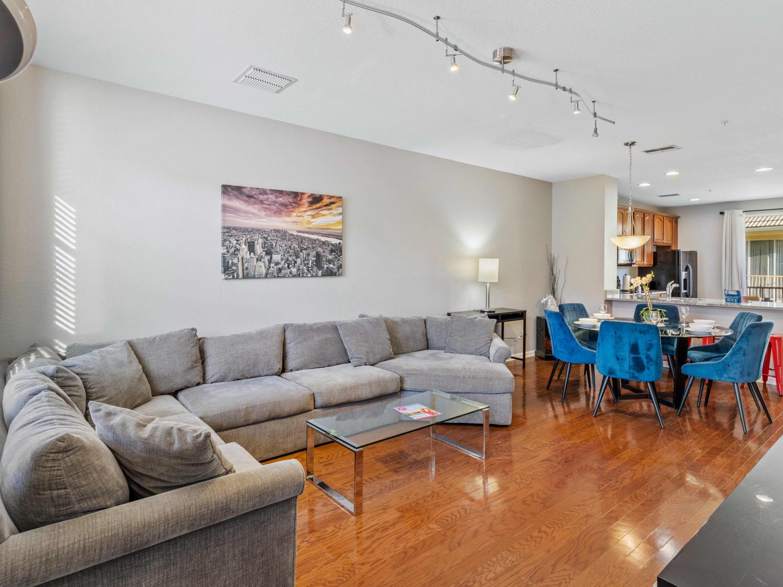 Elegant living area of the townhouse in Orlando - Cozy elegance meets modern convenience while relaxing on the comfy sofas - Complete with an indoor fireplace, smart TV, and adjacent dining area. - Refreshing ambiance with smooth lighting