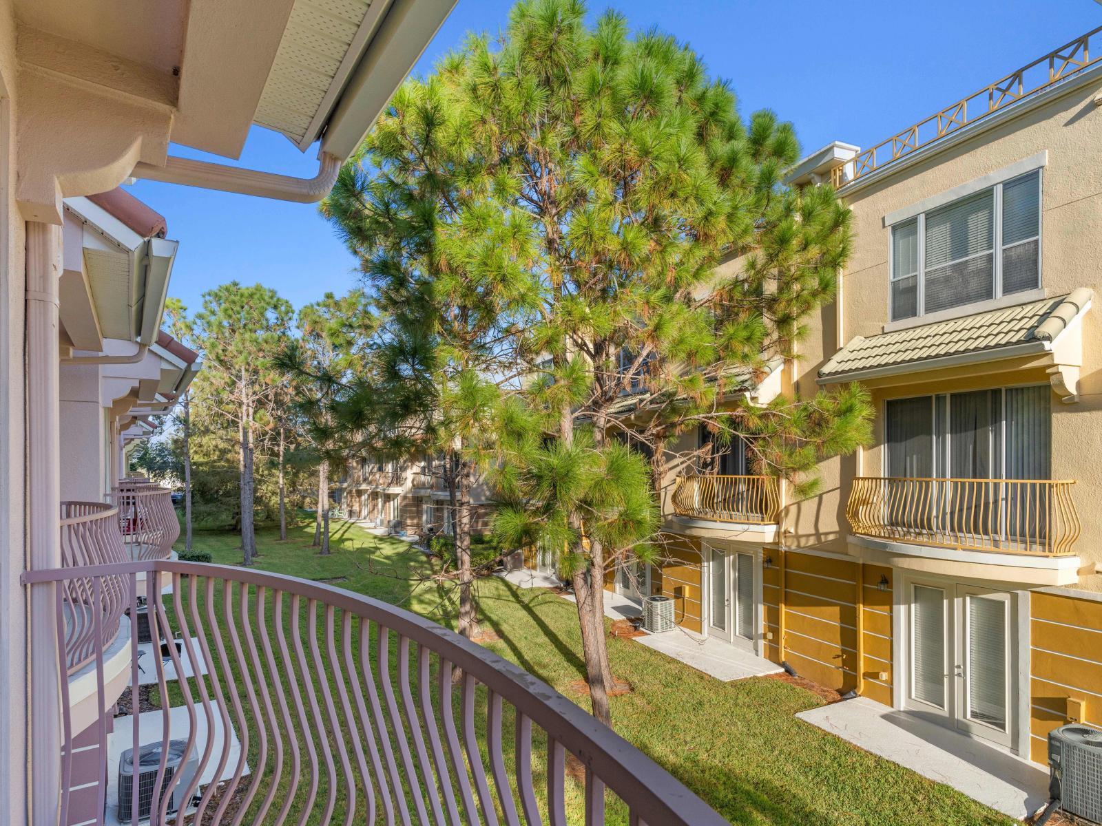 Indulge in breathtaking views from the private balcony of the townhouse at Vista Cay Resort in Orlando - Every glance unveils a panorama of serenity and beauty. - Enjoy the lush surrounding views