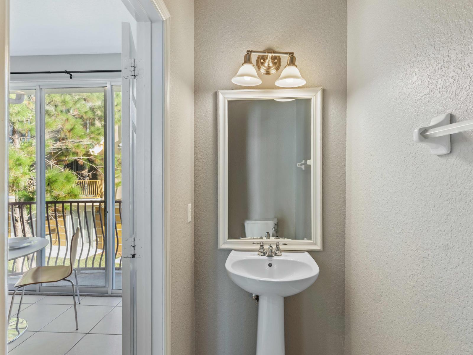 Convenience meets style in the half bath near the kitchen and living room – where modern design and functionality blend seamlessly, offering comfort and ease for guests and residents alike. Embrace the essence of refined simplicity.