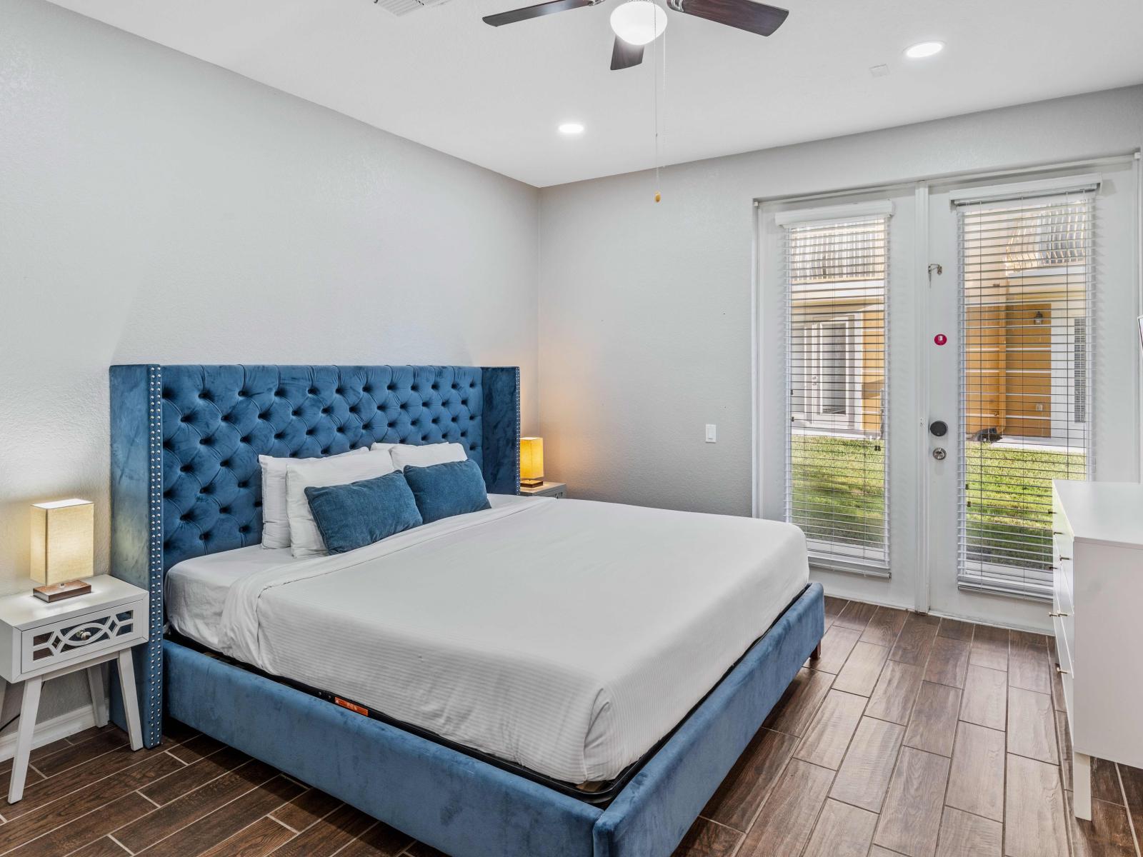 Discover unparalleled comfort in the spacious Bedroom of the townhouse in Orlando - Featuring a king-size bed and en-suite attached bathroom - Offering a serene retreat and effortless relaxation. - Well- appointed doors leading to the outdoor patio