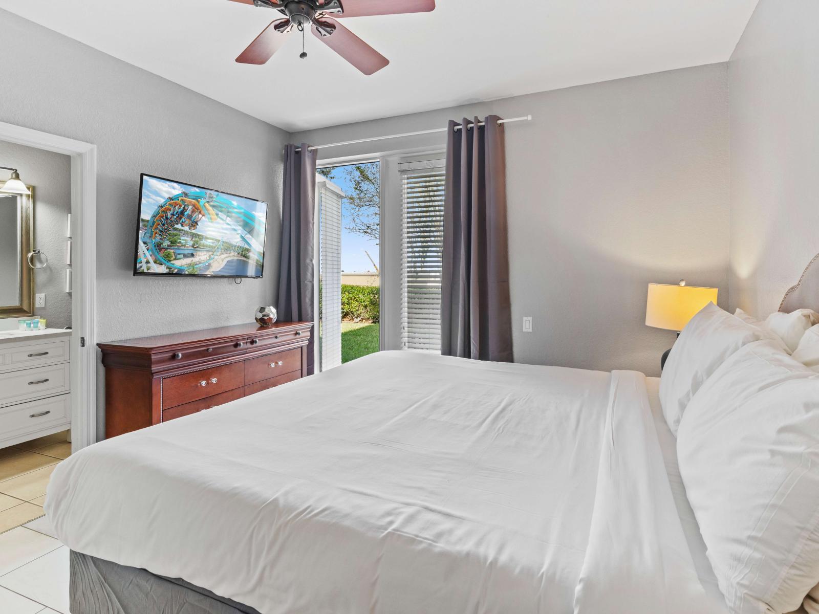 Masterful Comfort: Bedroom 1 boasts a king-size bed and an attached bathroom with a walk-in shower.