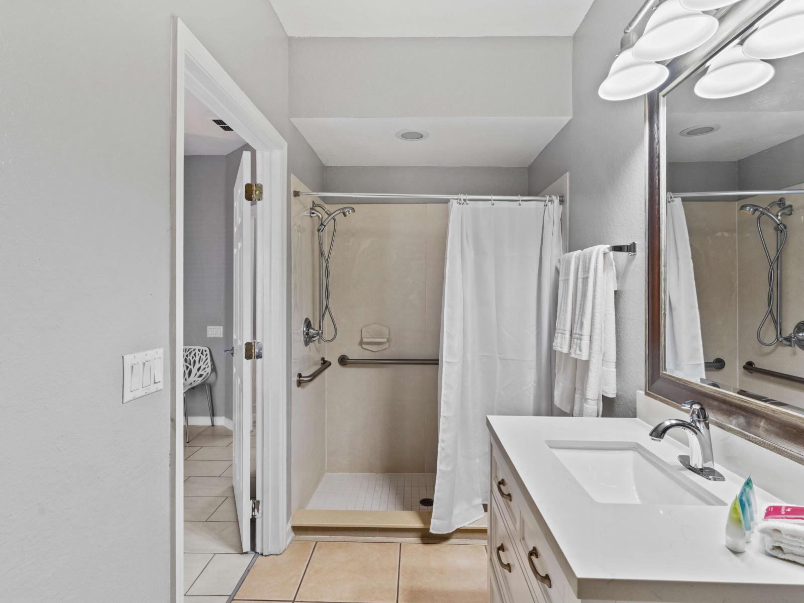 Modern Elegance: Bathroom 1 features a sleek walk-in shower, embodying modern elegance and functionality.