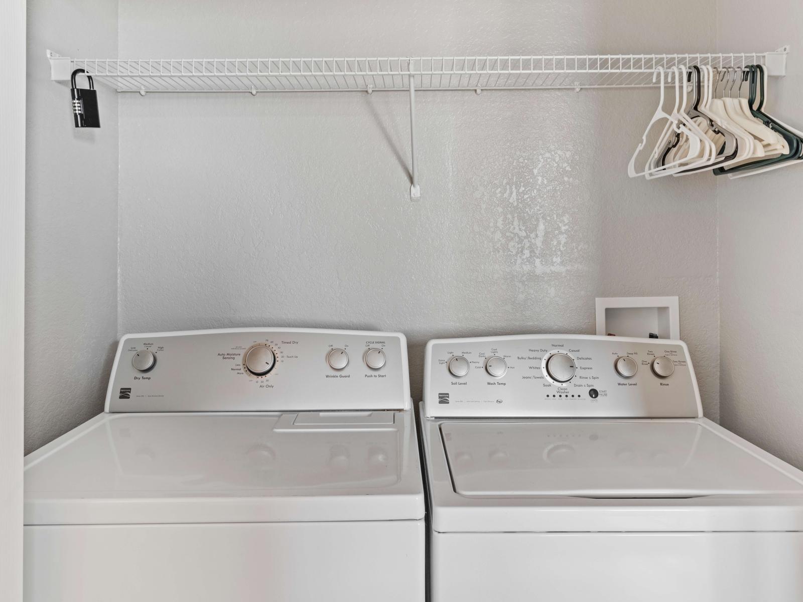 Behold the laundry area equipped with a full-size washer and dryer, offering convenience and efficiency for all your laundry needs.