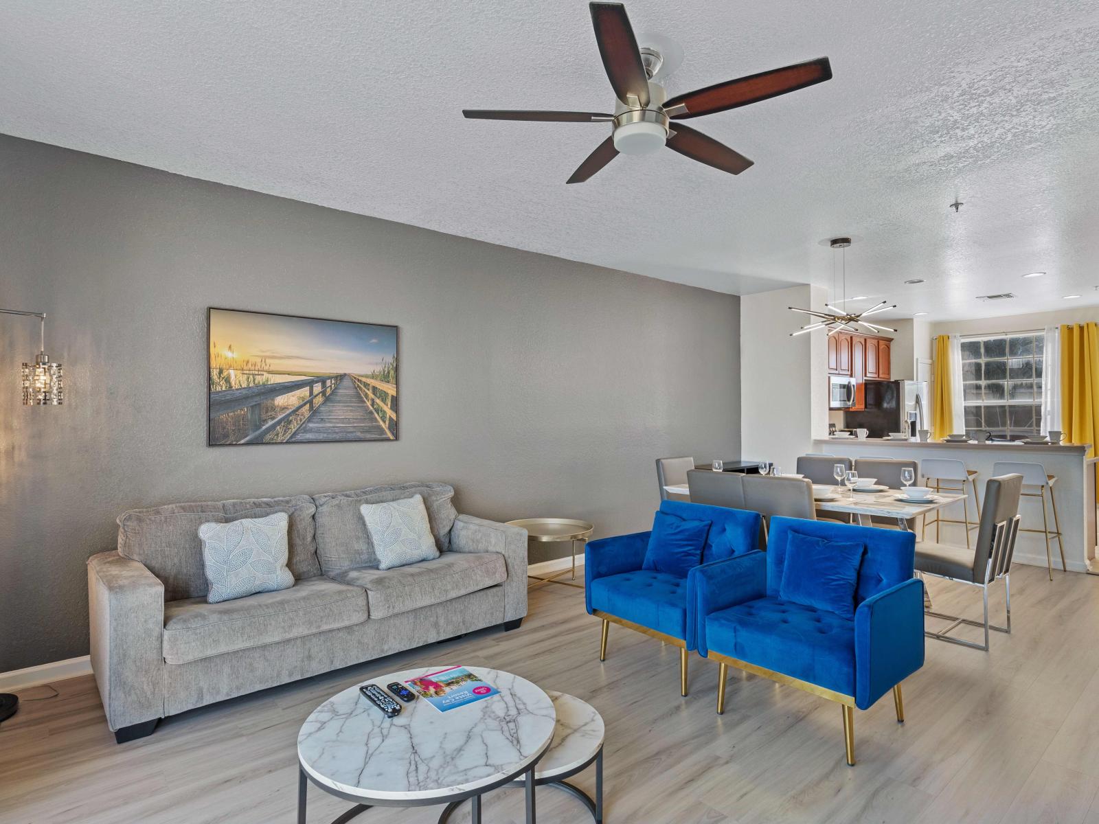 Welcoming Living area of the townhouse designed for relaxation in Orlando - Experience the epitome of sophistication in our stylish living room with Cozy sofas - Soak in panoramic views of the surroundings from large bright and airy windows