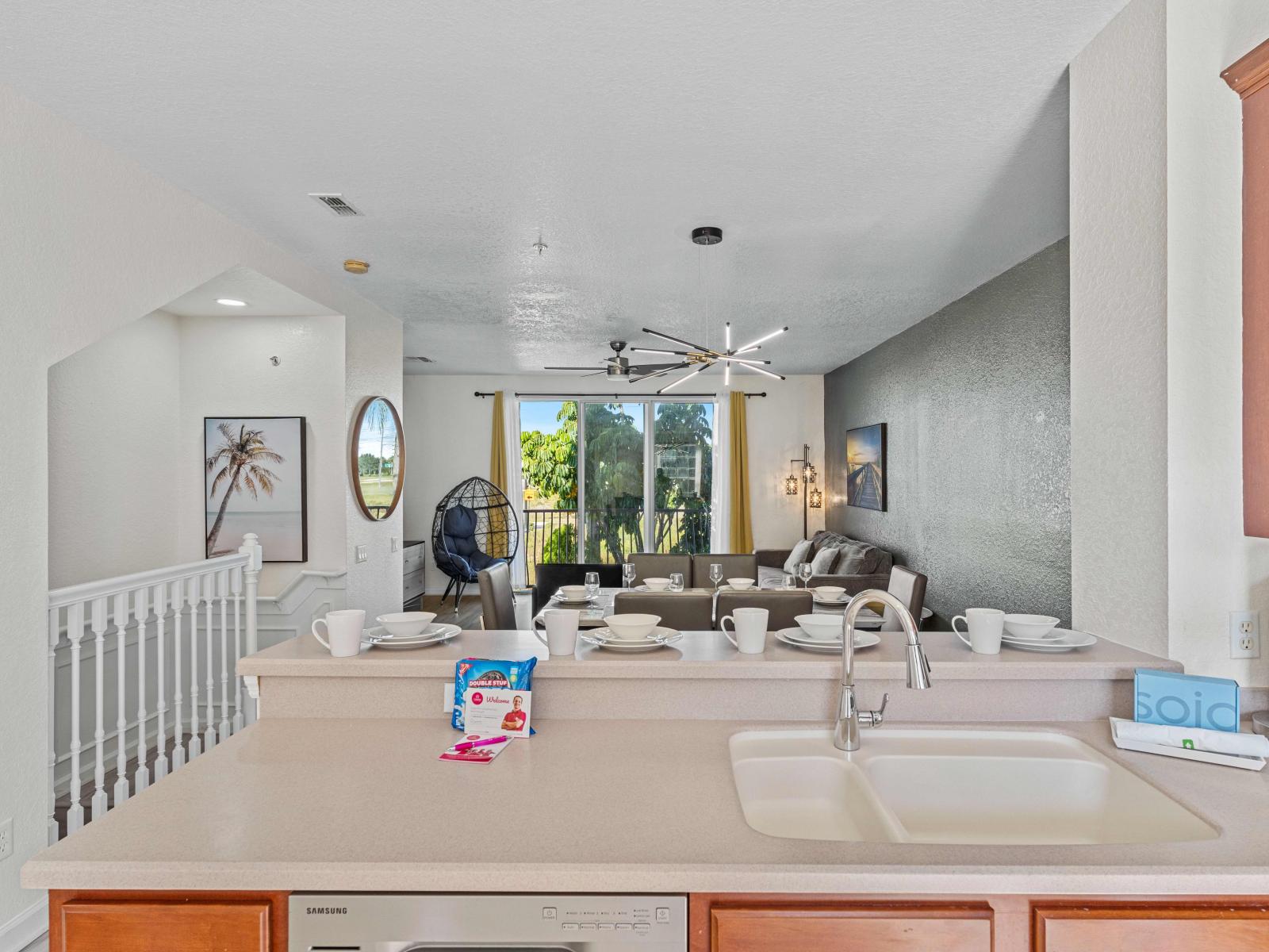 Stunningly Fully equipped kitchen of the townhouse with breakfast bar at Vista Cay Resort - Availability of high chairs - Sufficient storage space - Plenty space to work in the kitchen according to your ease - Elegantly brightened space