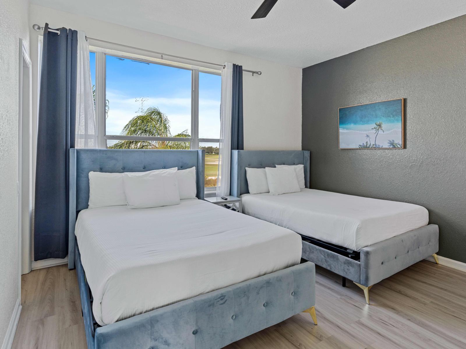 Spacious Bedroom of the townhouse at Vista Cay Resort in Orlando. - Features 2 Single beds and an en-suite bathroom, providing guests modern comforts. - Decored with aesthetic wall paintings - Large windows with beautiful views