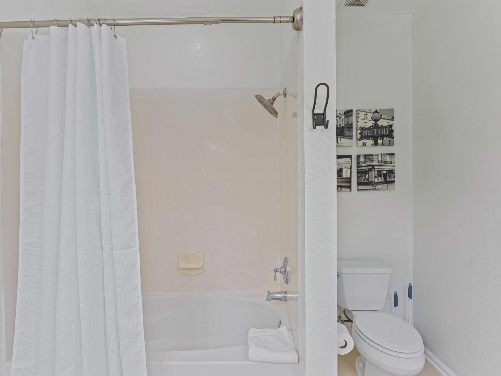 Escape to our classy bathroom of the Townhouse for a moment of relaxation and renewal at Vista Cay Resort - Designed to enhance your sense of well-being and comfort - Completed with a Cozy bathtub and shower combo and neat and clean toilet seat