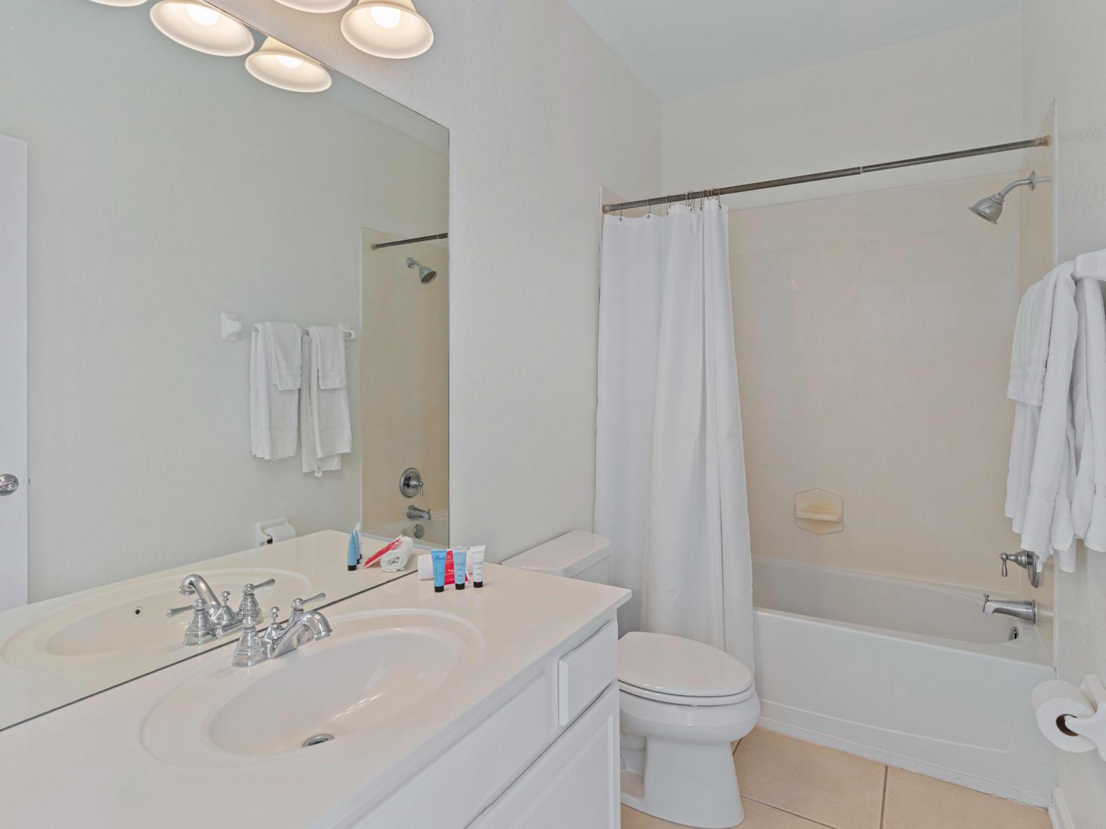 Experience the epitome of relaxation in our en-suite bathroom at Vista Cay Resort - Features a convenient tub/shower combination - Enjoy upscale amenities, plush towels and modern design Vanity - Treat yourself to a pampering session on Toilet seat