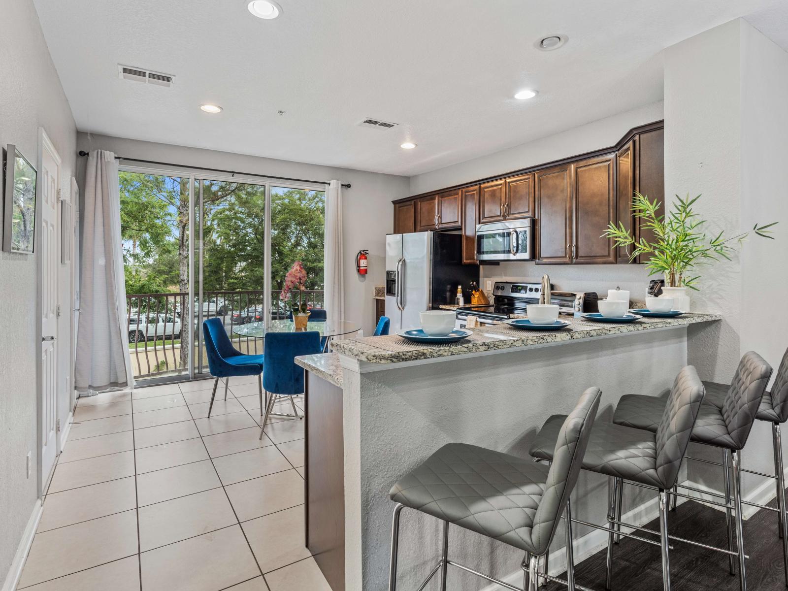 - Fully equipped kitchen of the townhouse in Orlando Florida - Marvelously designed breakfast bar with high chairs - availability of stainless steel appliances and all necessary accessories - Plenty of space to work according to your ease