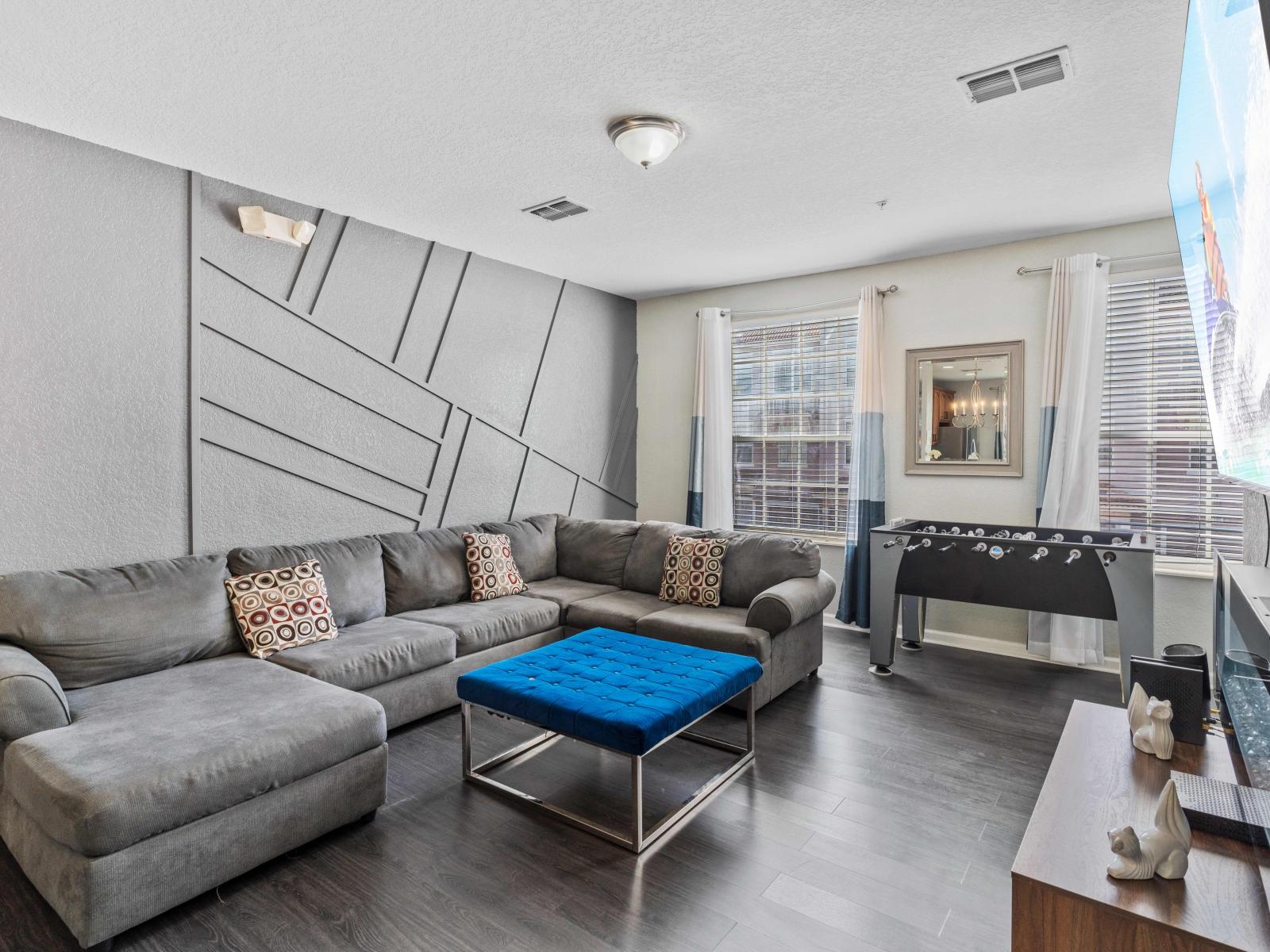 Living room with foosball table, electric fireplace and Smart TV