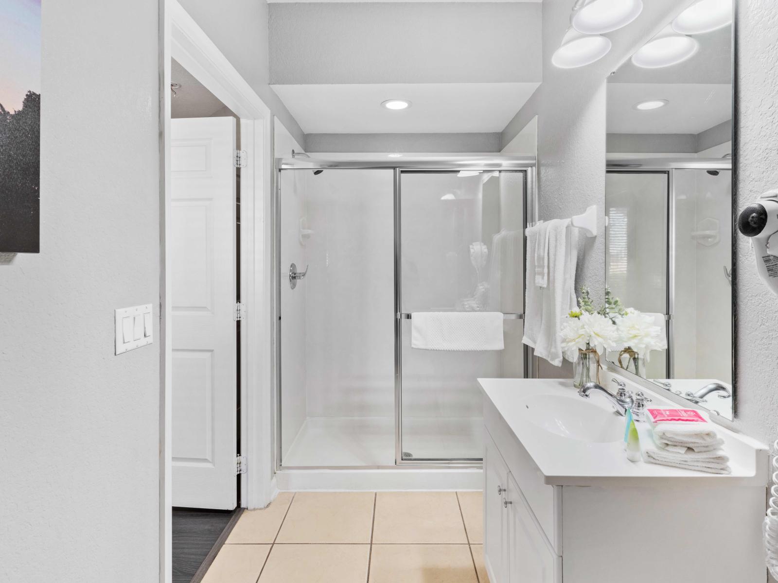 Modern Bathing Haven: Recharge and unwind in our bathroom with a walk-in shower, a space designed for both luxury and relaxation.