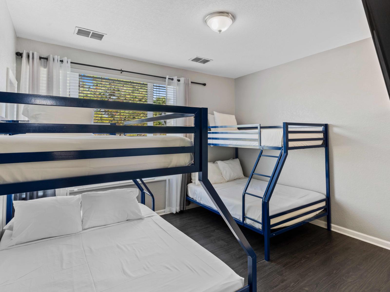 Sleepover Haven: Bedroom 3 Welcomes Guests with Two Single over Double Bunk Beds for Ultimate Comfort and Convenience.