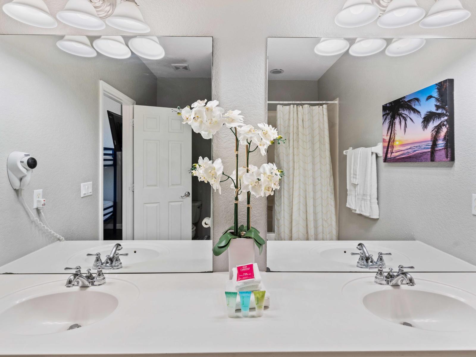 Indulge in Luxury: Unwind in Our Attached Bathroom 3 Featuring a Double Vanity and Tub/Shower Combination.