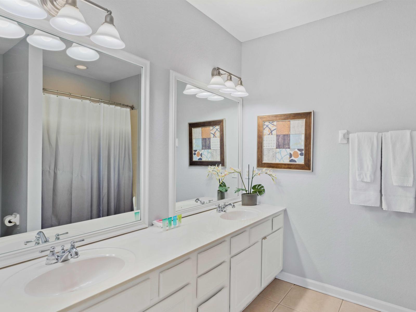 En-suite bathroom with double vanity and tub/shower combination