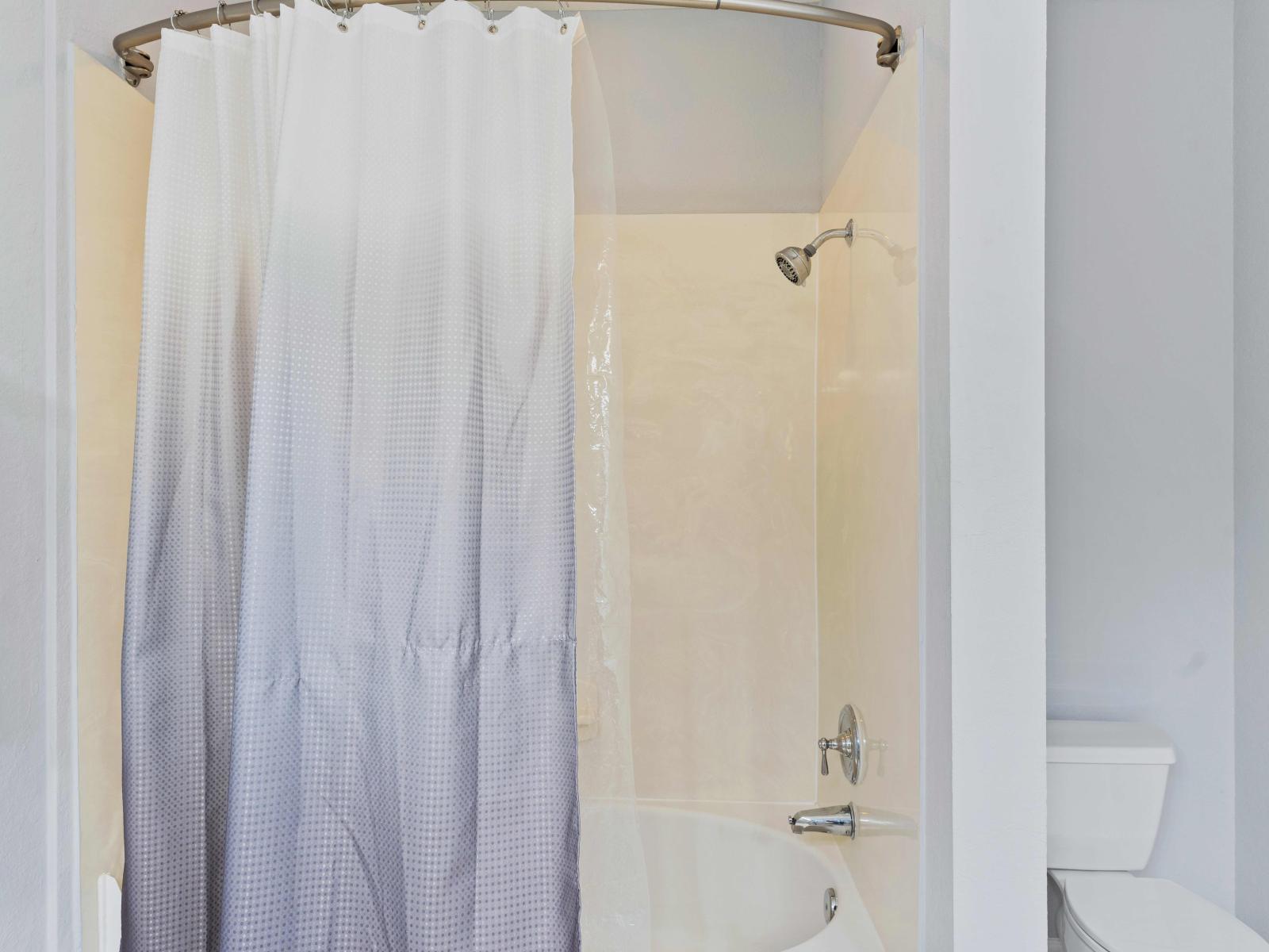 En-suite bathroom with double vanity and tub/shower combination