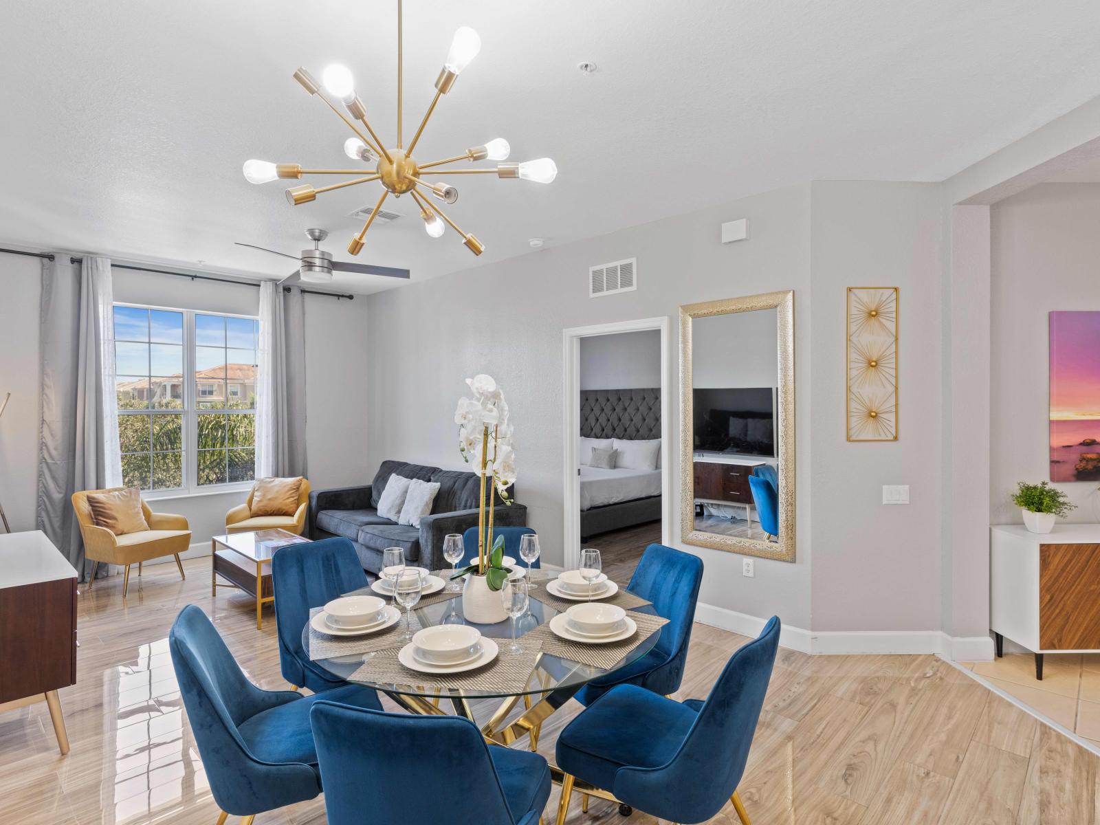 Elite Dinging Area of the condo in Orlando - Offers an inviting space to gather and enjoy memorable meals  - Glorious 6 Persons Dining under a majestic chandelier - Bright and airy window with beautiful views