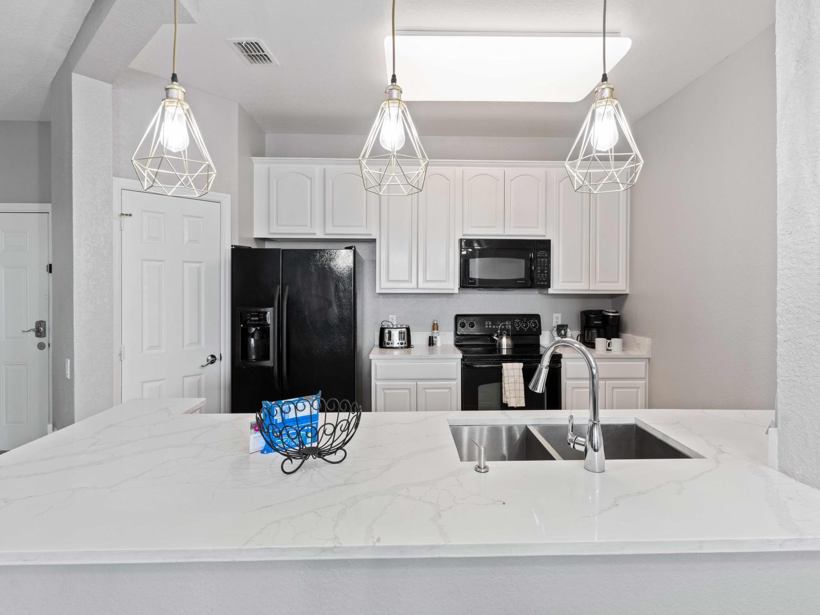 Exclusive kitchen of the condo in Orlando - Availability of stainless steel appliances and all kitchen accessories - Elegant design with smooth lighting to enhance the ambiance - Smartly Designed cupboards with plenty of storage space