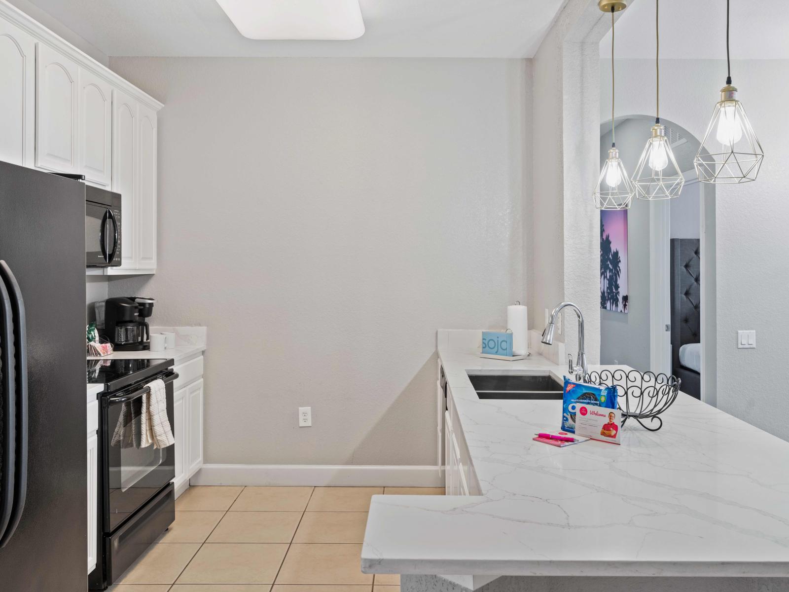 This modern kitchen space seamlessly integrates into the living area, creating a welcoming environment for cooking and socializing.