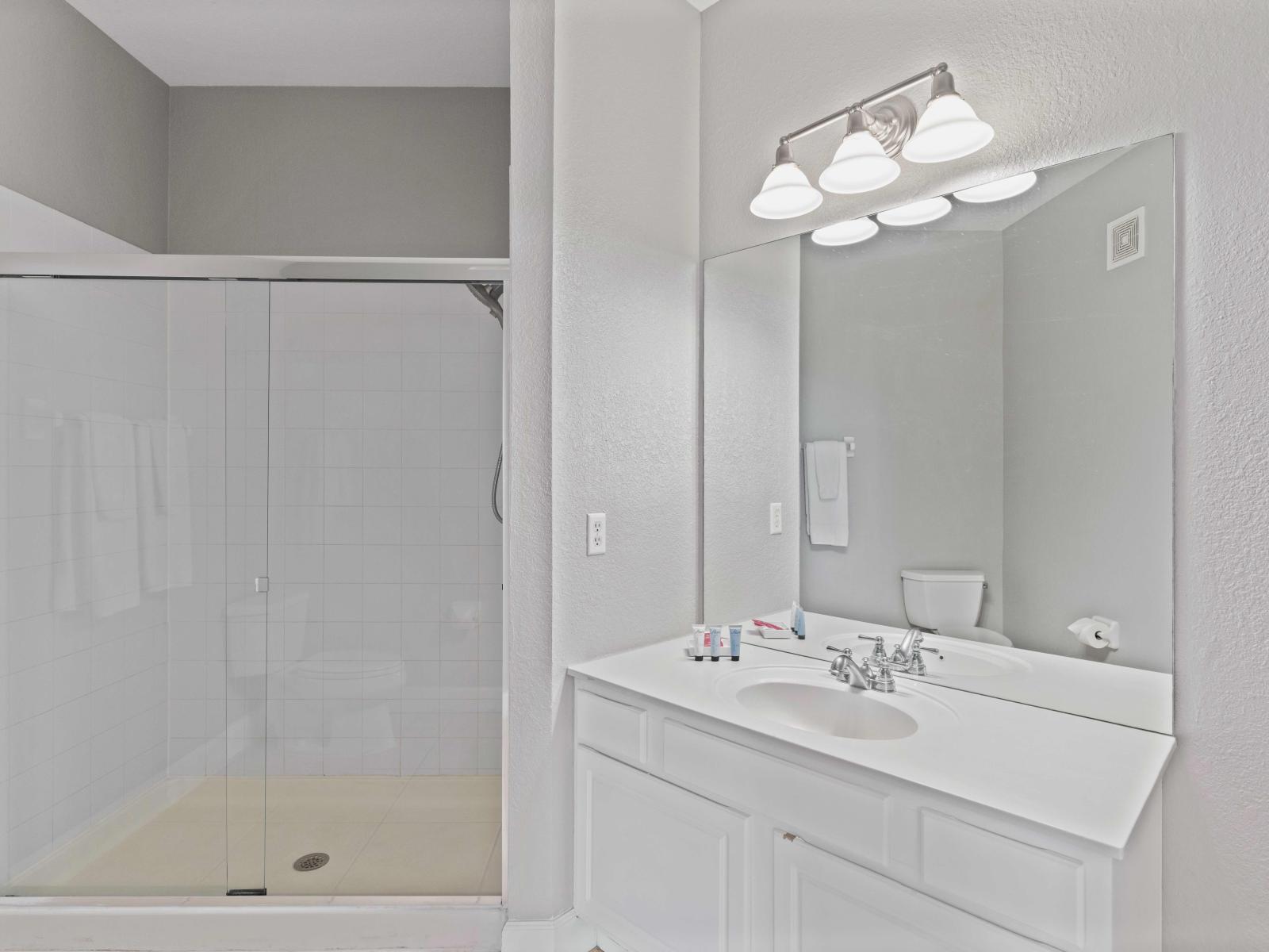 Stylish bathroom of the condo in Orlando - Vanity area exudes timeless elegance and sophistication - Its clean lines and bright aesthetic - Elegant bathroom with luxurious walk-in shower area