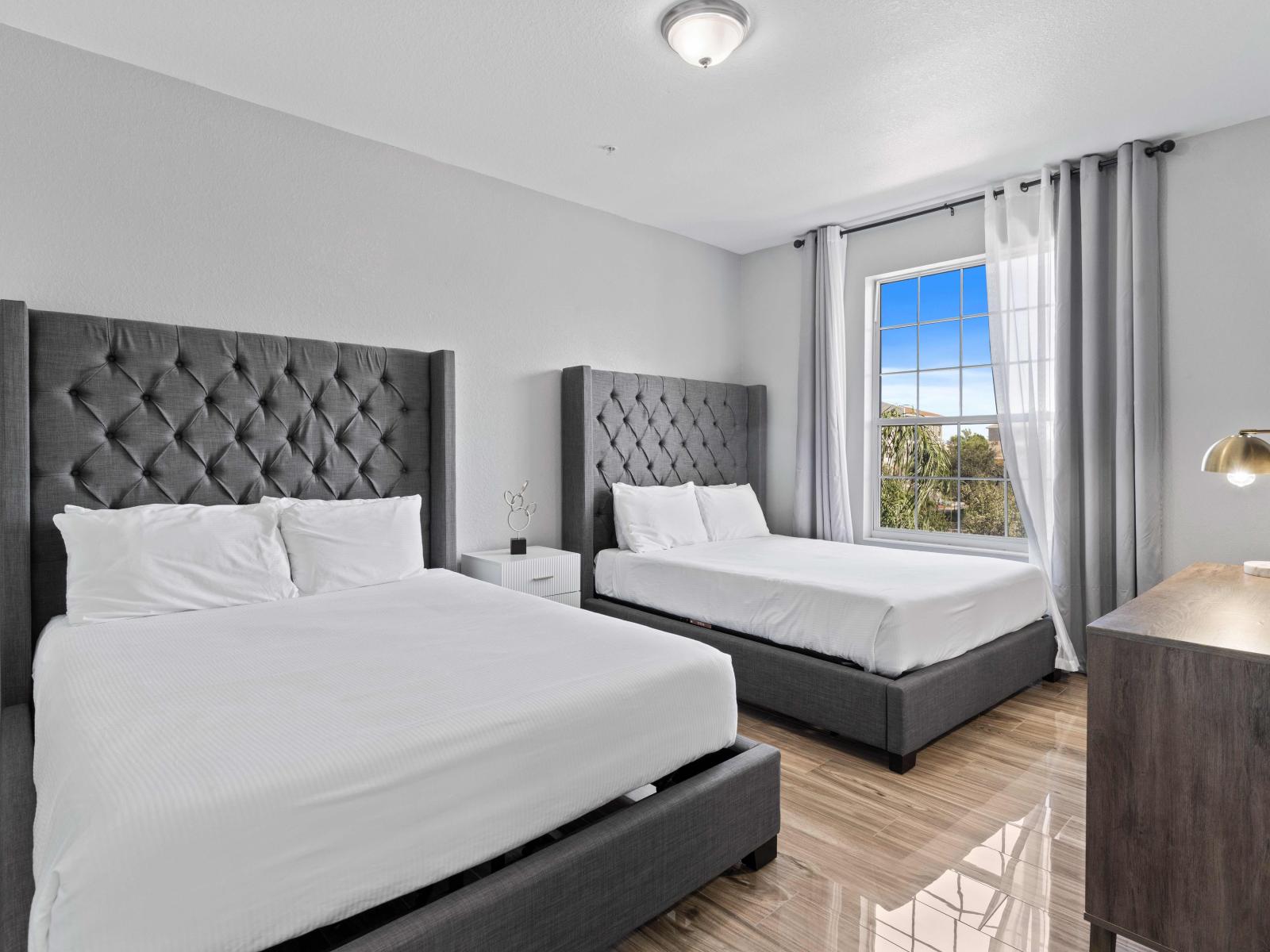 Exquisite Bedroom of the condo in Orlando - Comfy twin double beds with elegant lamp - Smart TV and Netflix - Spacious bedroom offering comfort and style - Wooden furnished floor