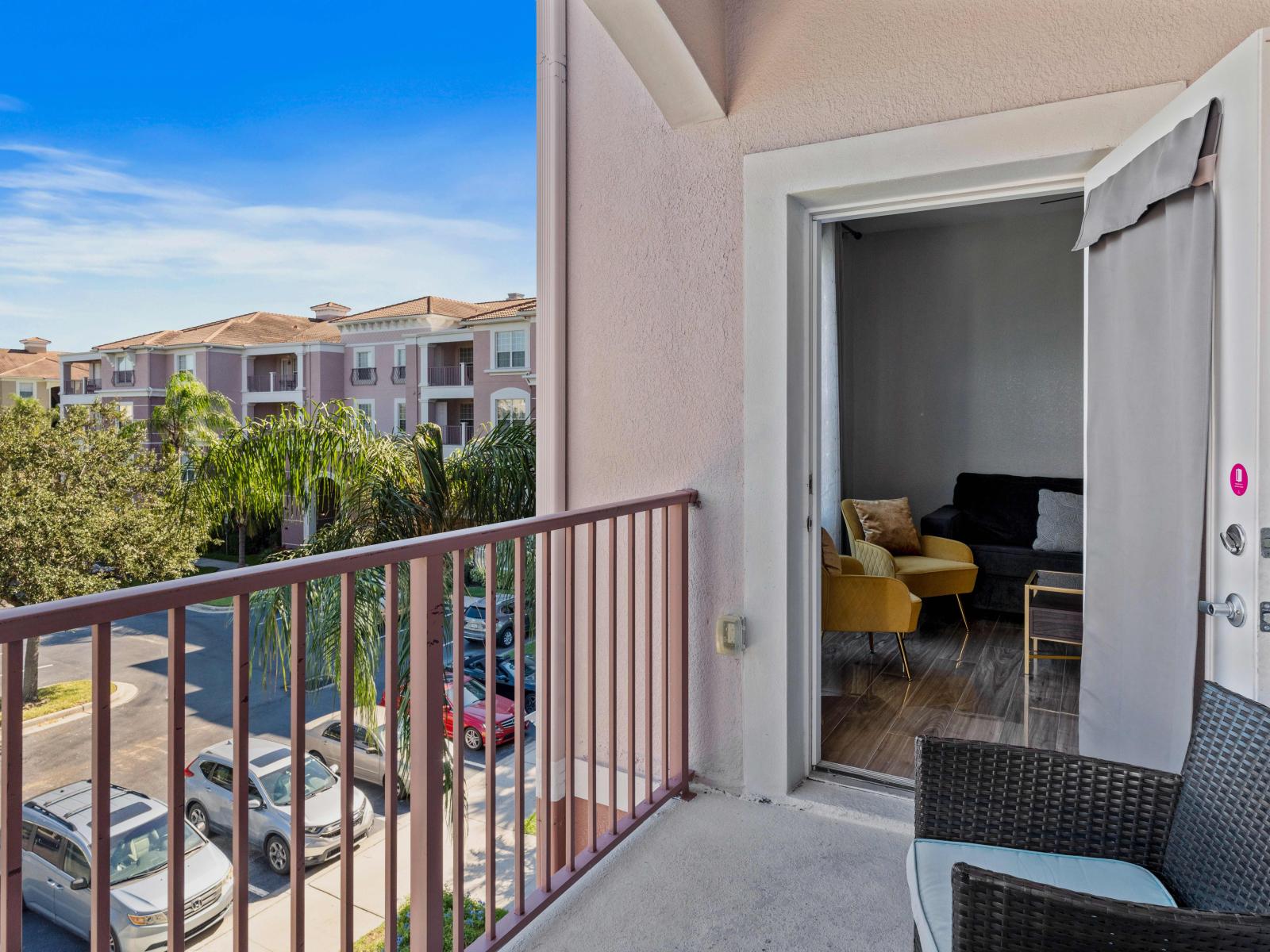 Alfresco elegance awaits: Step onto the balcony with outdoor sitting space at Vista Cay Resort, where guests are embraced by the charm of outdoor living amidst panoramic views and gentle breezes.