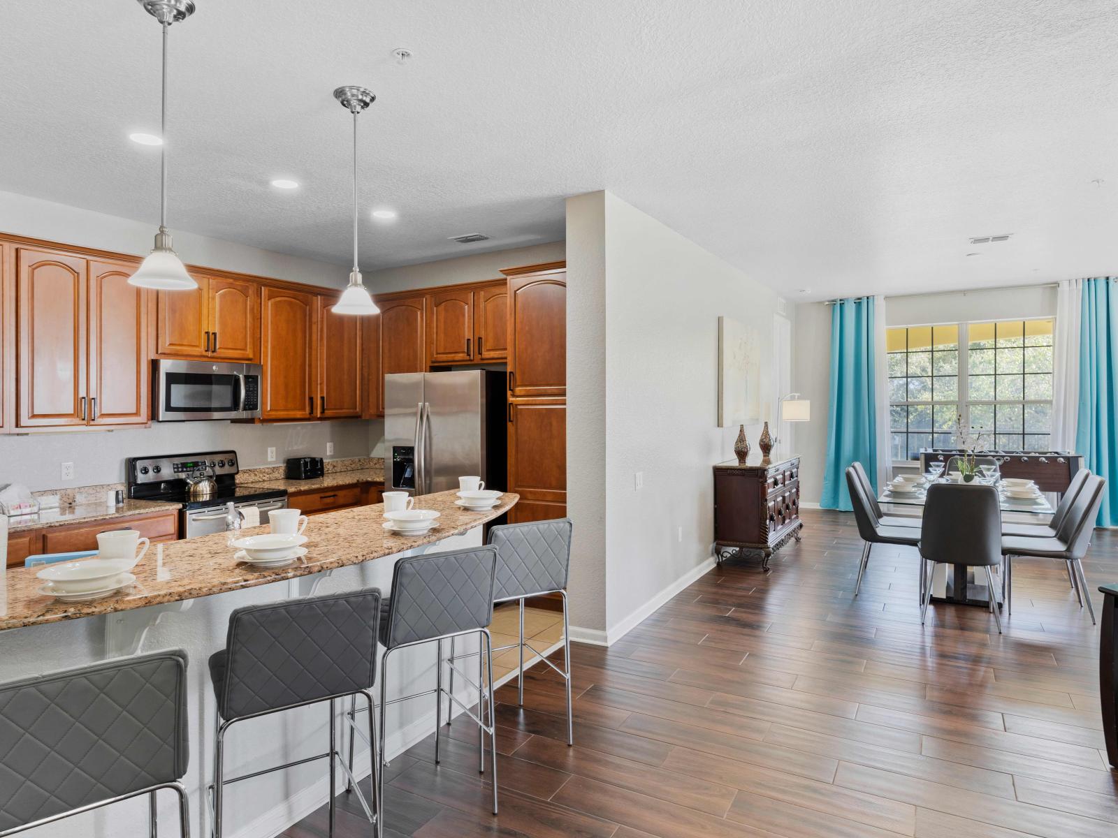 Our fully equipped kitchen boasts a sleek design and top-of-the-line appliances, perfect for whipping up delicious meals. The breakfast bar adds a convenient space for casual dining or gathering with loved ones while cooking.