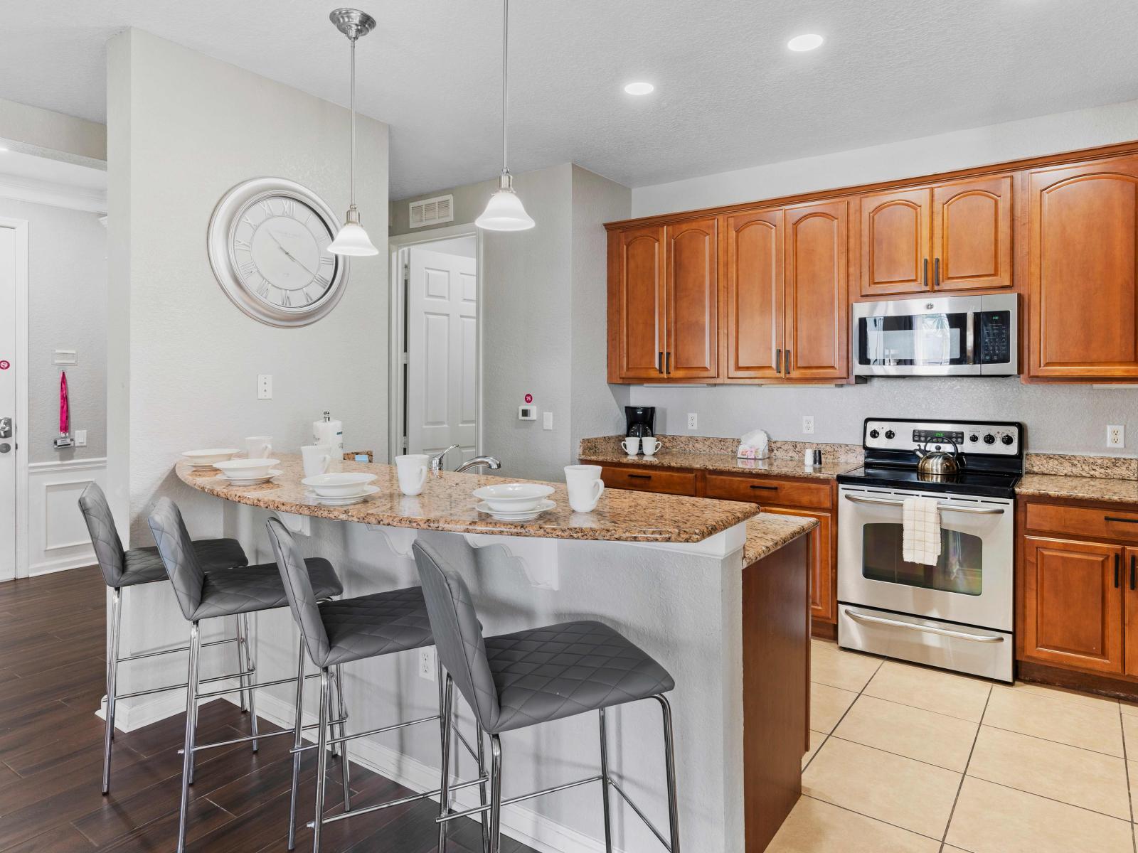 Our fully equipped kitchen boasts modern amenities and ample space for culinary adventures. The breakfast bar provides a cozy spot for casual dining or socializing while enjoying delicious meals prepared with ease.