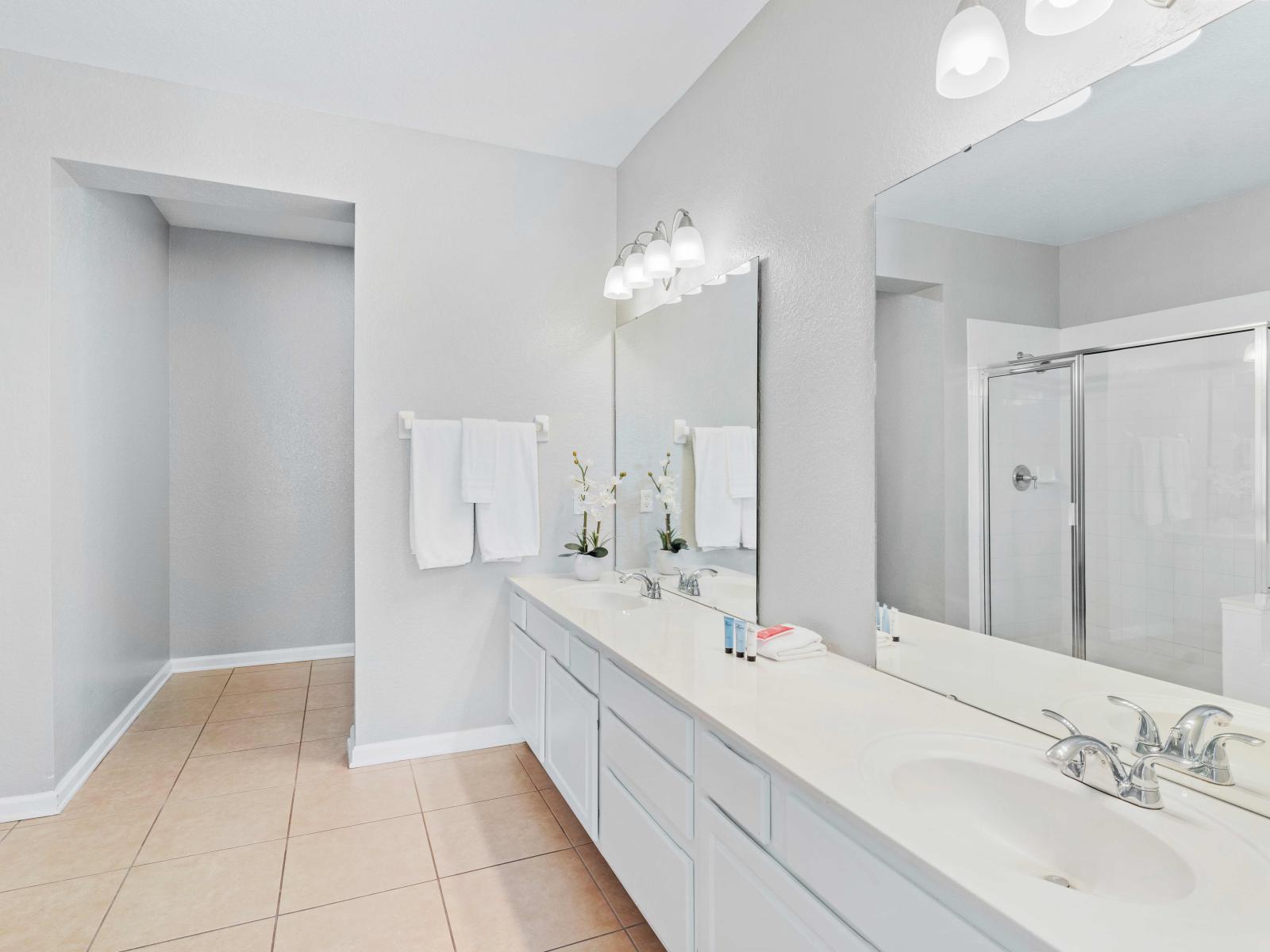 Pamper yourself in Bathroom 1's luxurious amenities, including a relaxing tub, convenient walk-in shower, and elegant double vanity. It's the perfect sanctuary for unwinding after a long day of adventures.