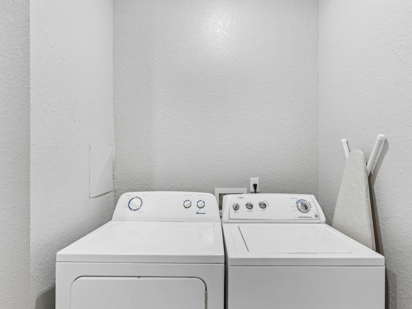 Behold the laundry area equipped with a full-size washer and dryer, offering convenience and efficiency for all your laundry needs.