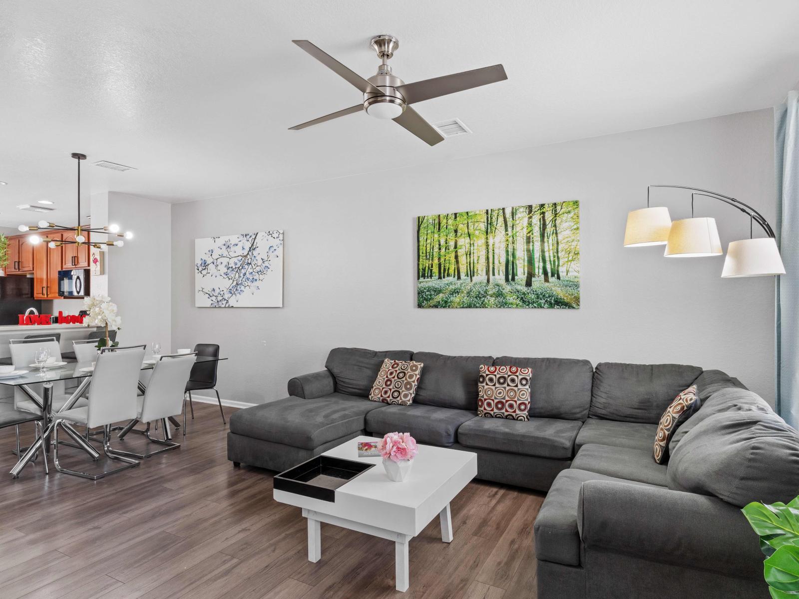 The living room exudes warmth with its rich color details, creating a cozy haven where every corner invites relaxation and moments of blissful serenity.