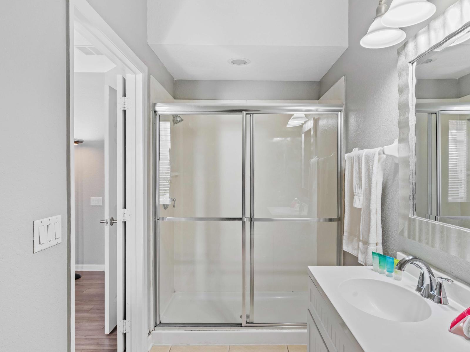 Walk into Relaxation: Our Airbnb bathroom invites you to indulge in a modern retreat, complete with a spacious walk-in shower for a luxurious bathing experience