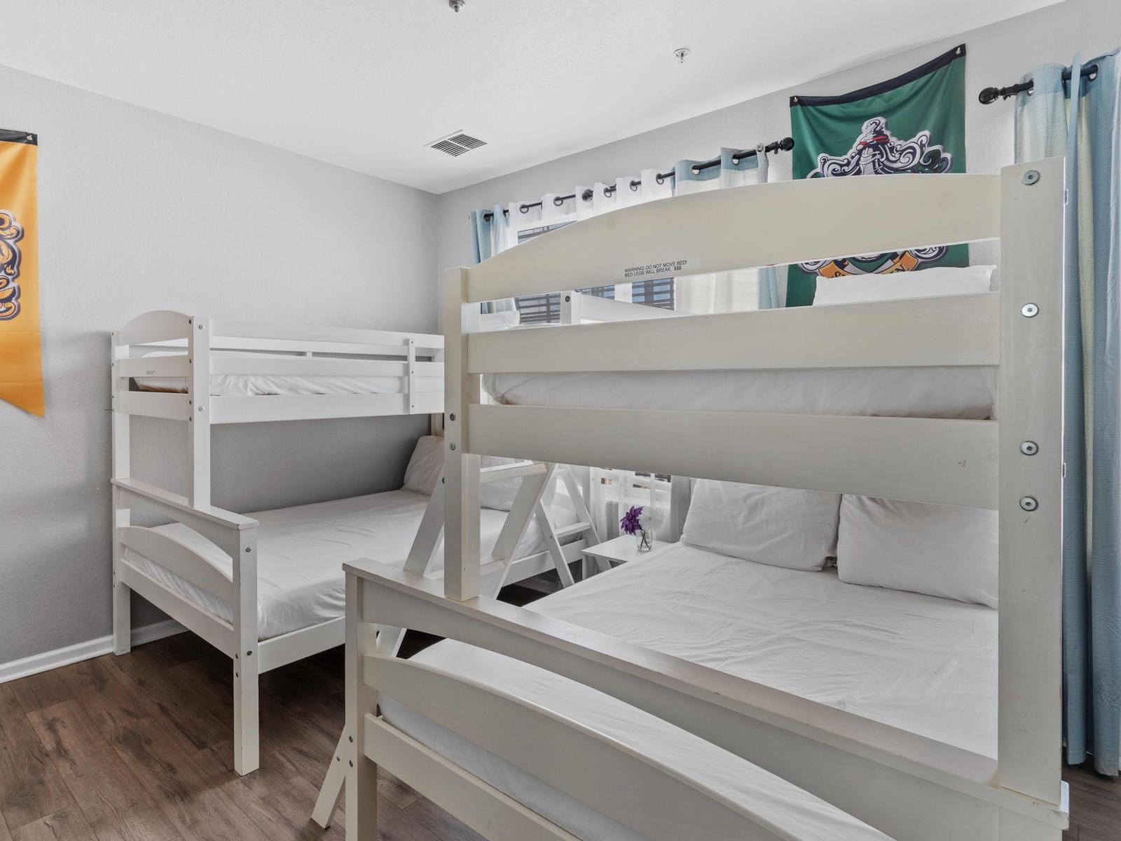 Bedroom 2 boasts two single-over-double bunk beds, offering ample sleeping space for kids or extra guests. With cozy accommodations and a playful vibe, it's the perfect retreat for a fun-filled night.