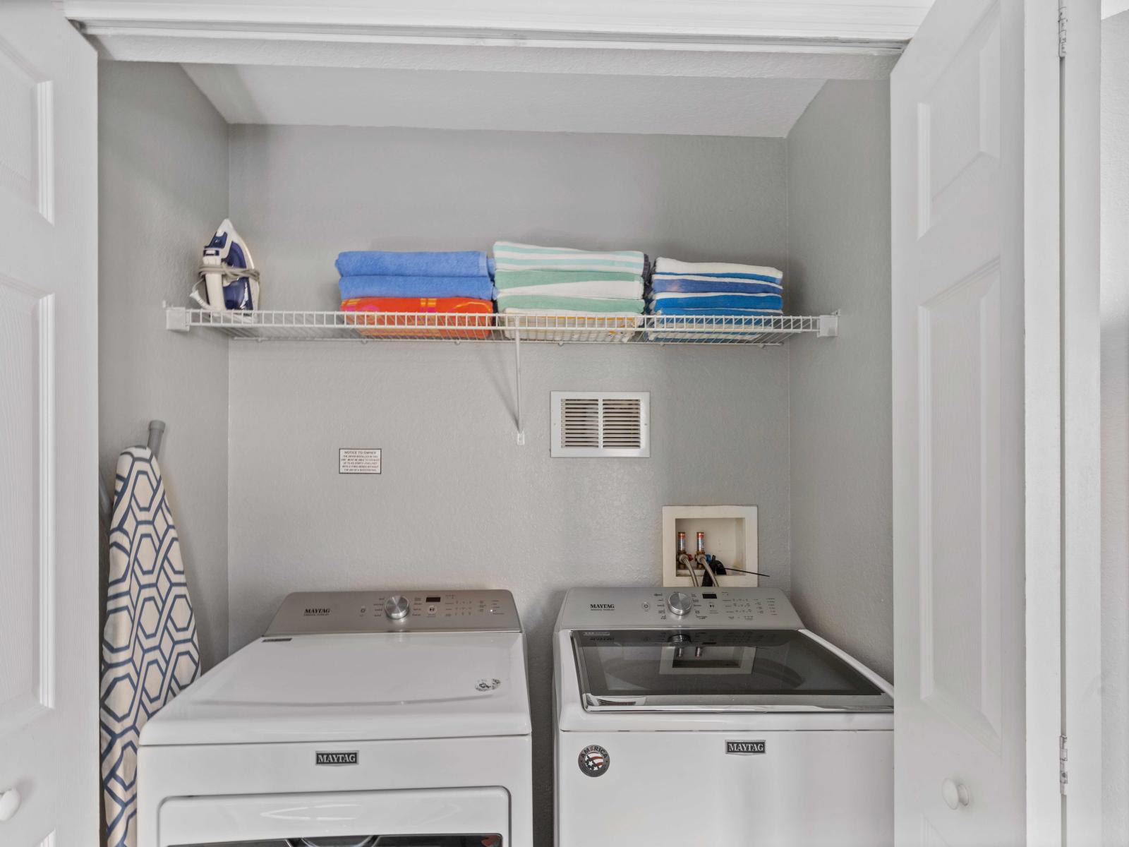 The laundry area boasts a full-size washer and dryer, ensuring that you can easily keep your clothes fresh and clean throughout your stay.