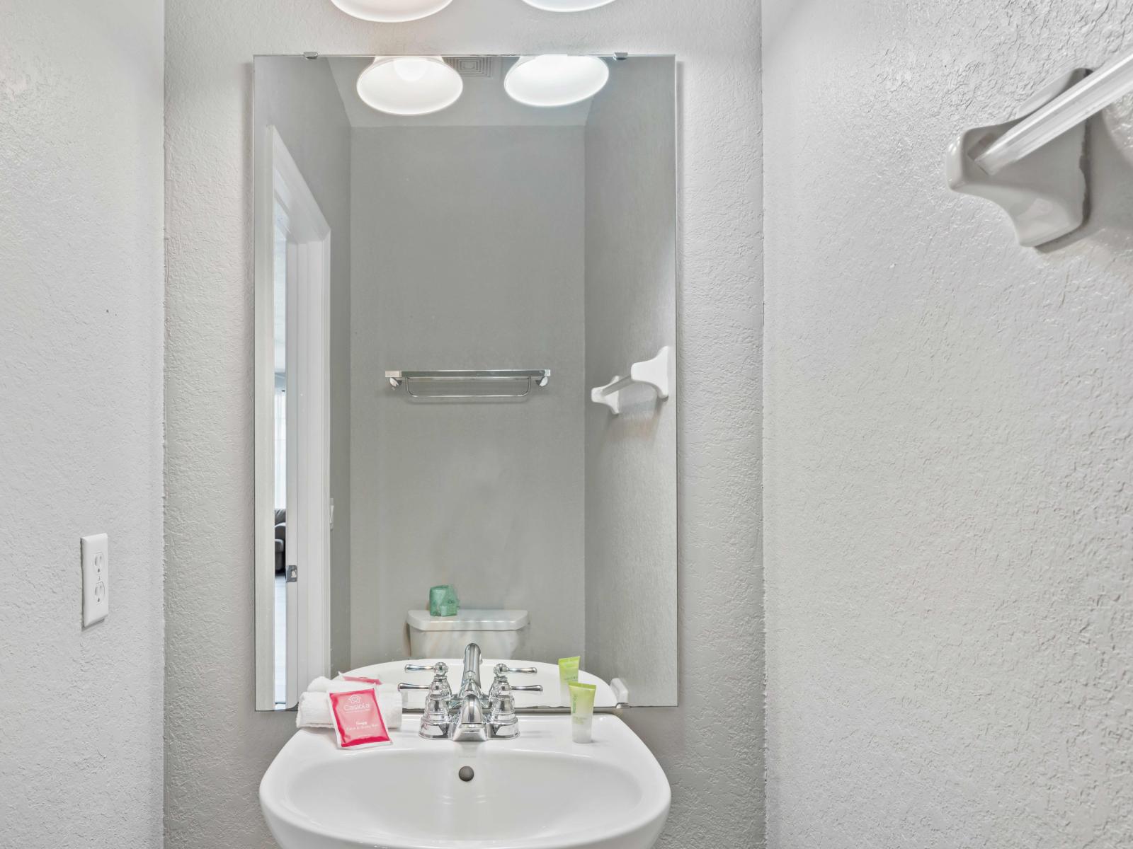 The half bathroom near the kitchen at Vista Cay Resort offers guests a practical and accessible space for quick refreshments, ensuring comfort and convenience during their stay