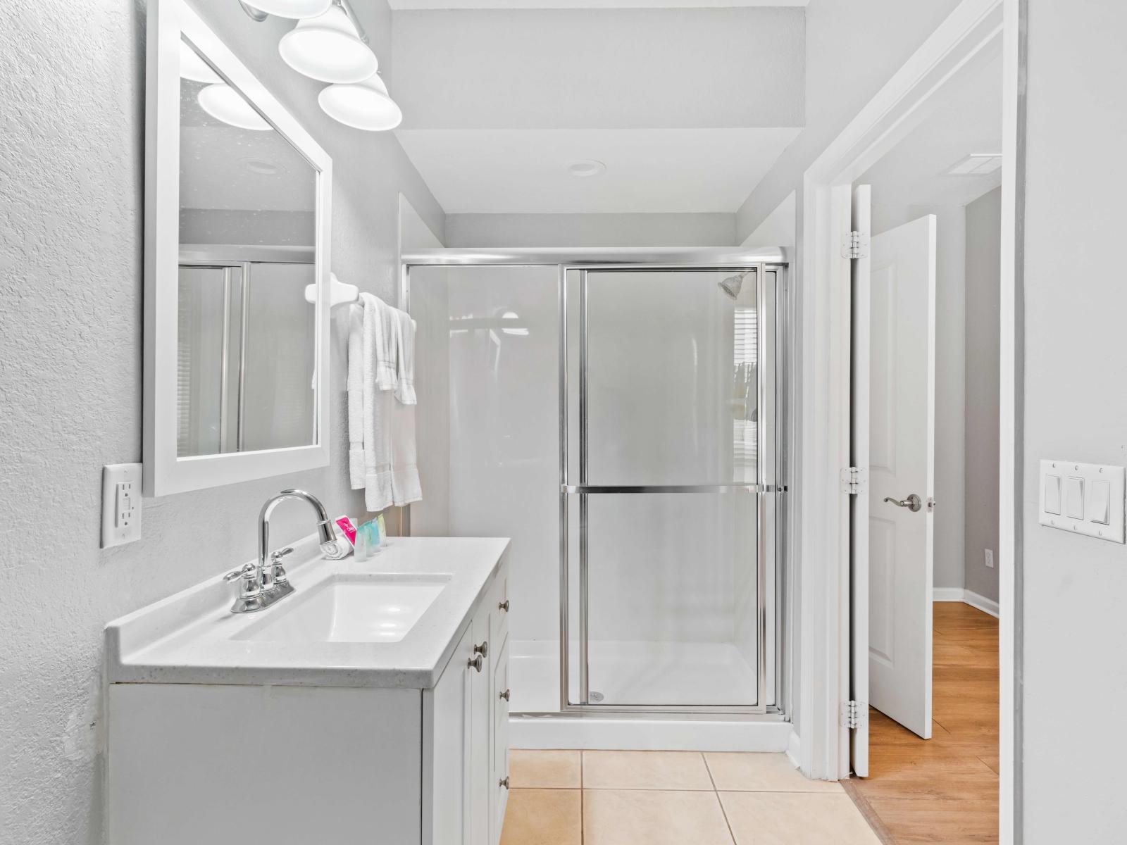 Luxe Bathroom of the townhouse in Orlando Florida - Elegant bathroom with luxurious fixtures and finishes - Chic design featuring a sleek vanity and upscale lighting - Seamless design featuring a glass-enclosed shower for a modern touch