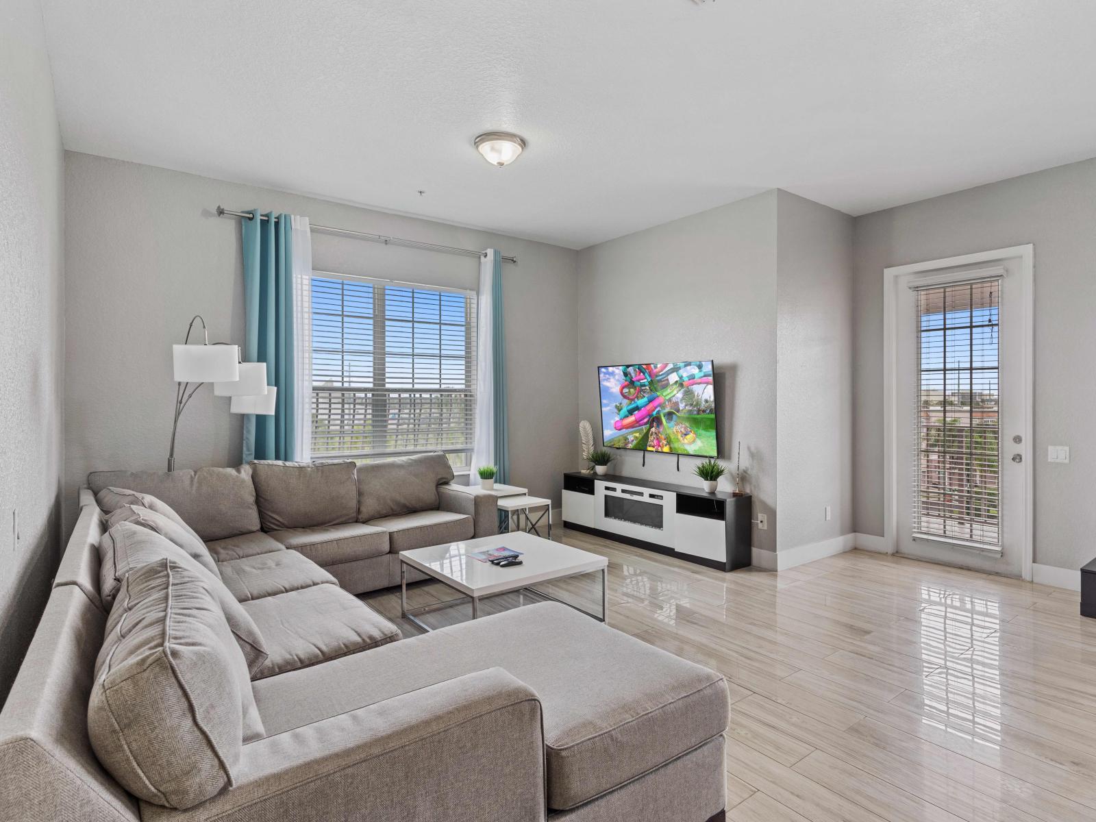 Relax and Unwind: This Living Room Welcomes You with a TV, Comfortable Couch, and Accent Chairs, Adorned with Decoratives for Added Charm and Comfort.