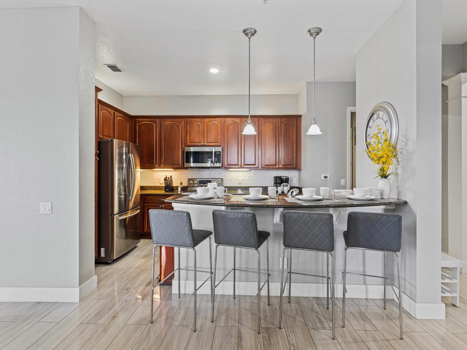 Start your day right in our fully equipped kitchen featuring a convenient breakfast bar. From morning coffee to hearty breakfasts, this space is designed for culinary delights and shared moments.