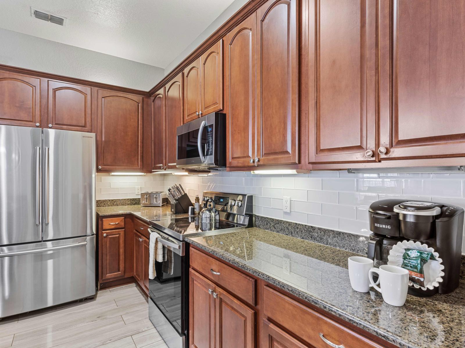 The Fully equipped kitchen offers an engaging spot to gather for family dinners, boasting updated appliances and granite countertops.