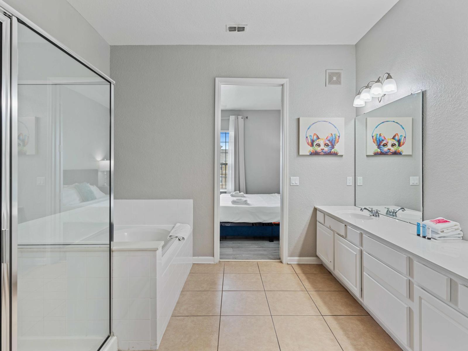 Bathroom 1 Offers Double Vanity, a Spacious Soaking Tub, and a Refreshing Walk-in Shower for Ultimate Relaxation.