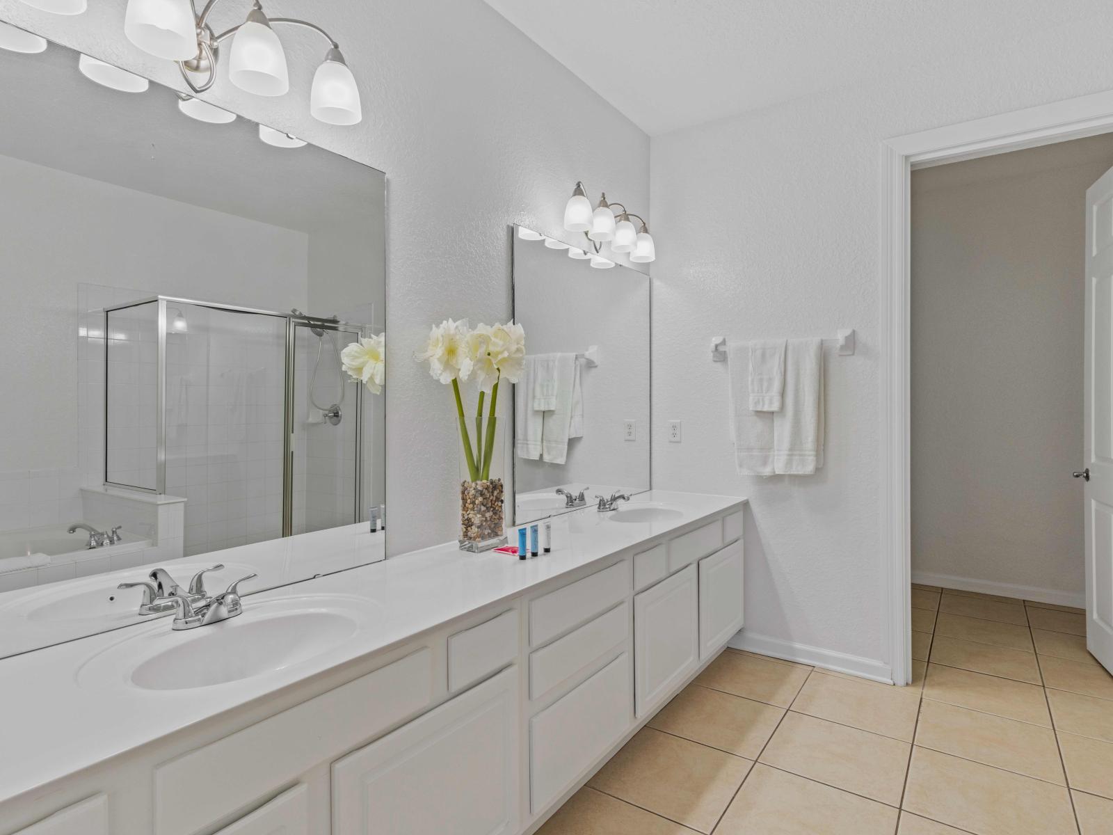 Spacious bathroom with double sink, walk-in shower and bath tub