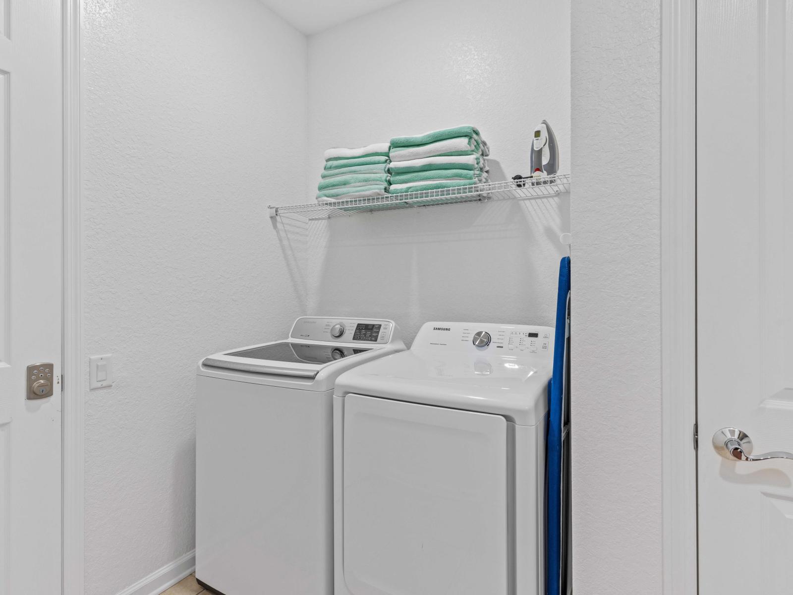 The laundry area boasts a full-size washer and dryer, ensuring that you can easily keep your clothes fresh and clean throughout your stay.